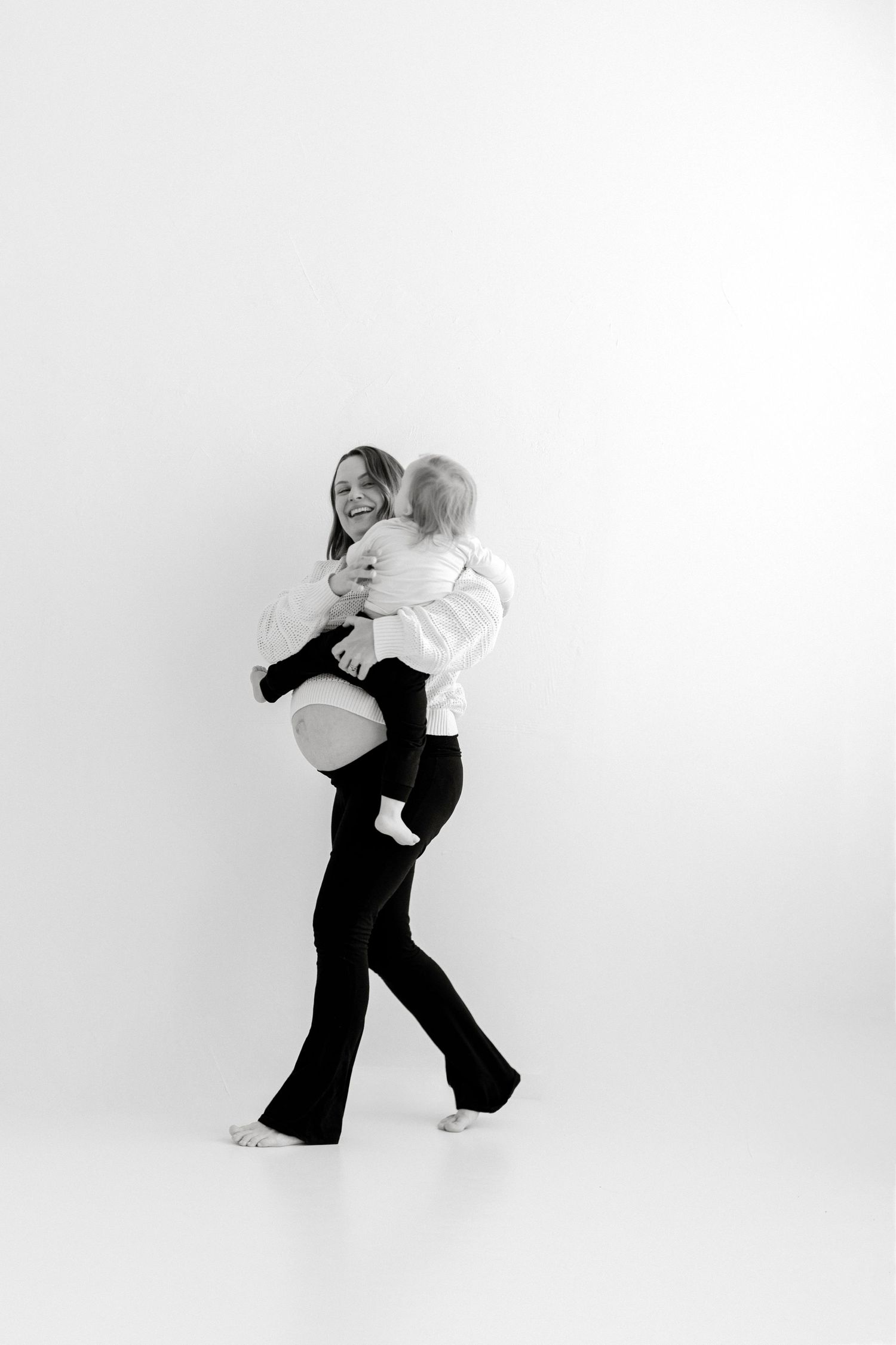 Silhouette of dancers performing a graceful sequence of contemporary dance movements against a white background.