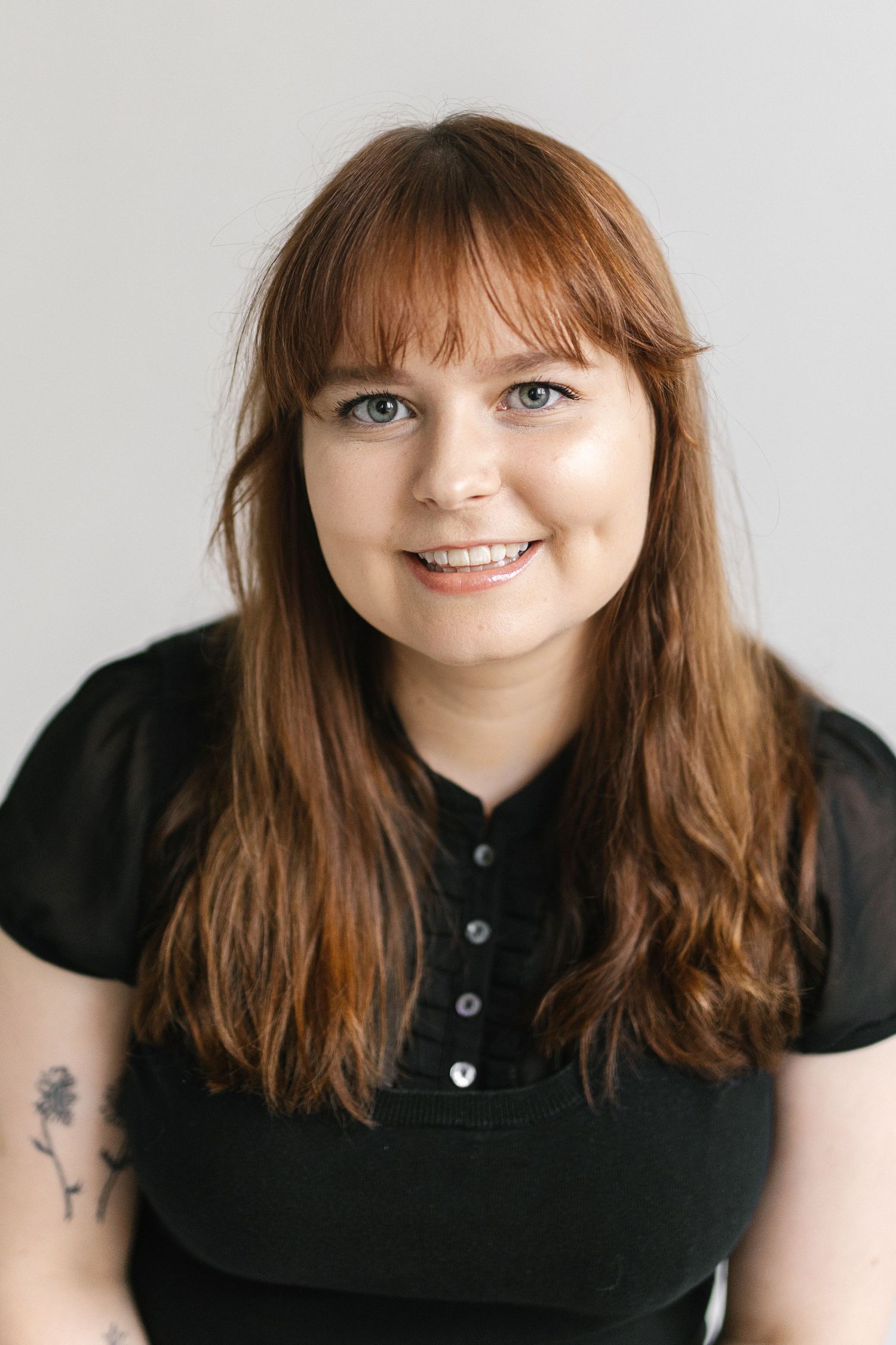 Cheerful portrait series in a black polo shirt showing various expressions.