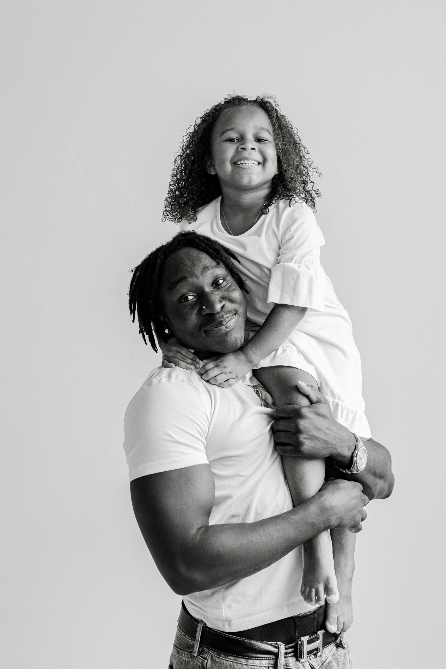 Candid black and white portraits showing loving embraces and joyful moments.