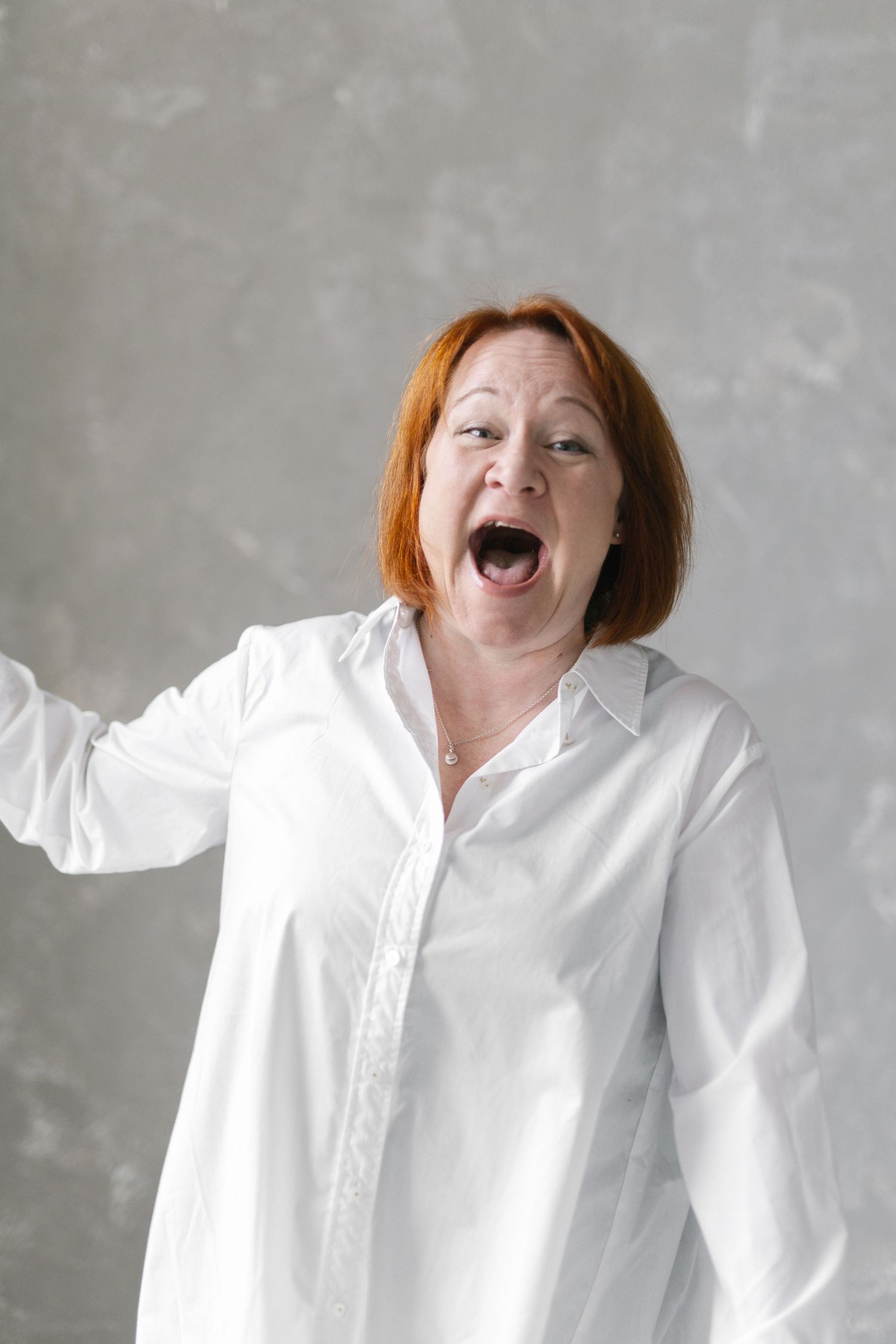 Energetic portrait series in a white button-down shirt with animated expressions.