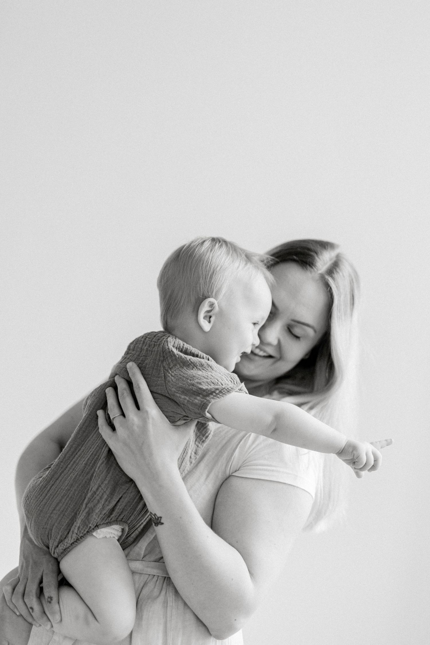 Sweet black and white portrait series showing tender moments between parent and baby.