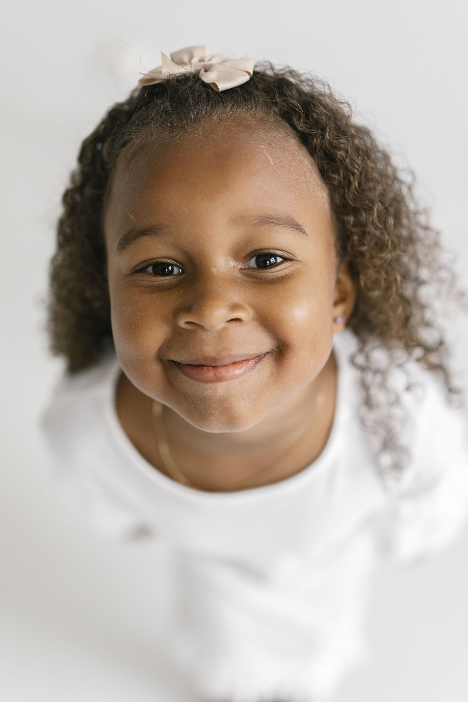 Close up portraits showing joyful expressions against white background.