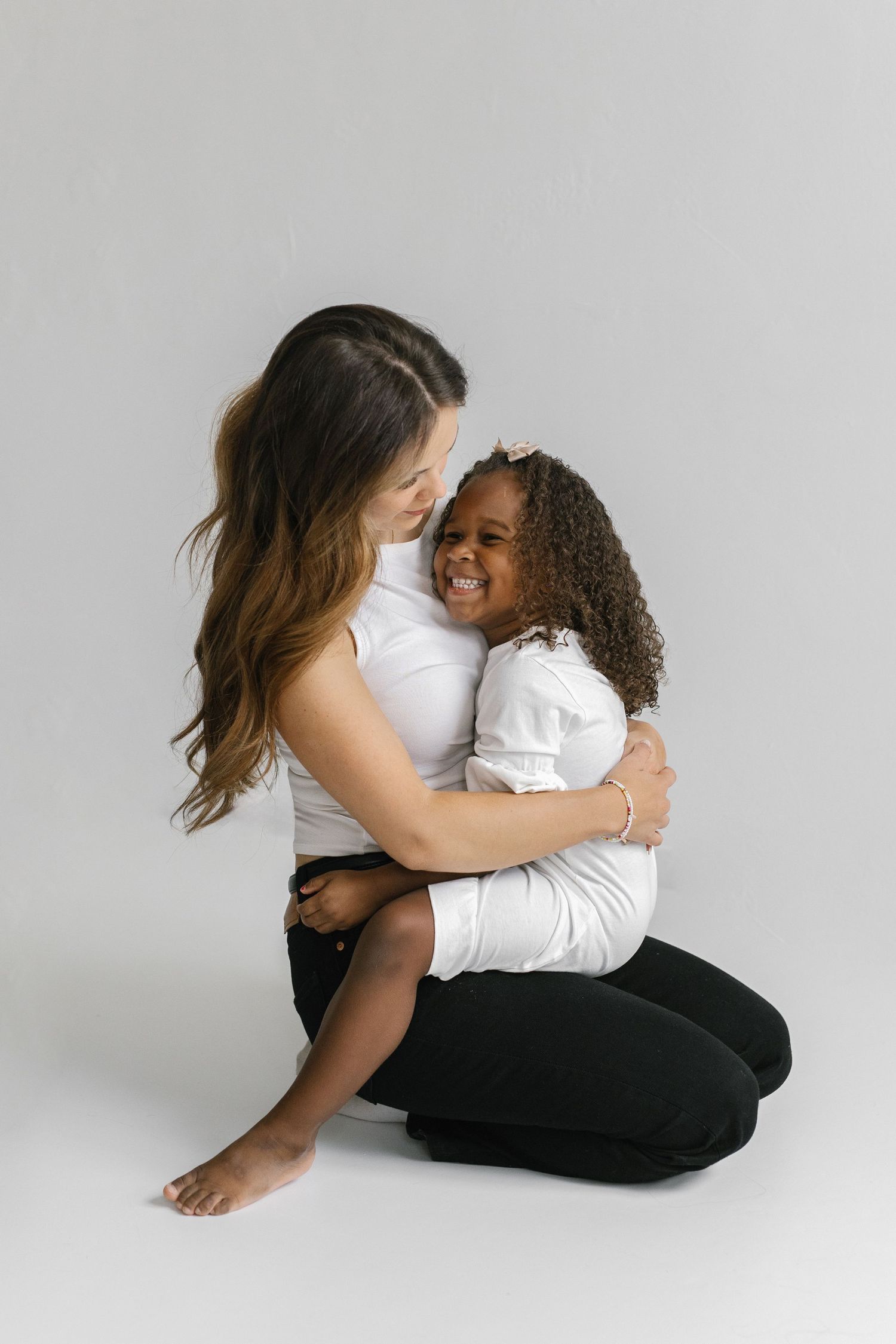 Sequence of loving poses showing two people hugging and bonding on a white backdrop.