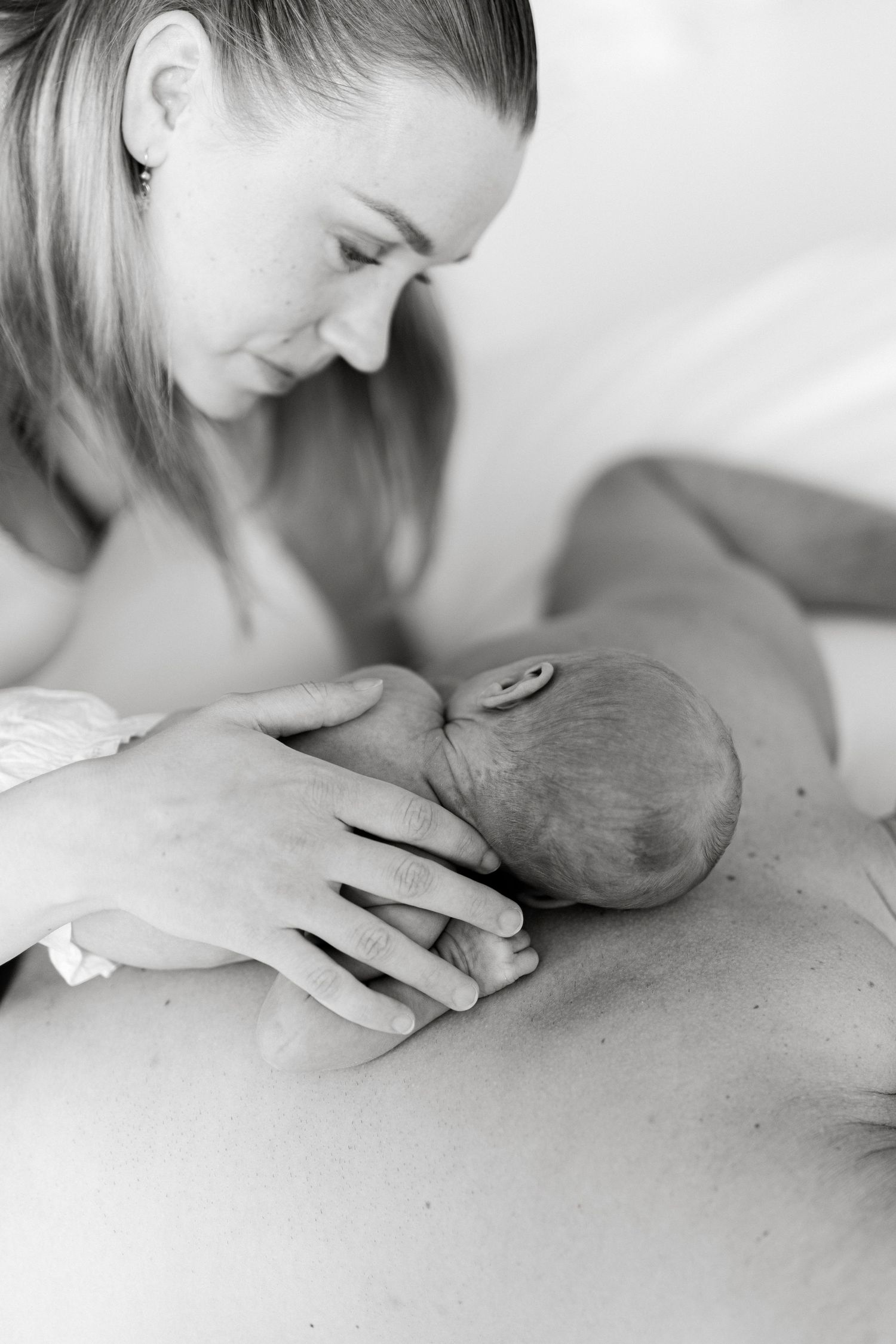 Intimate black and white close-up of gentle kisses and tender moments.