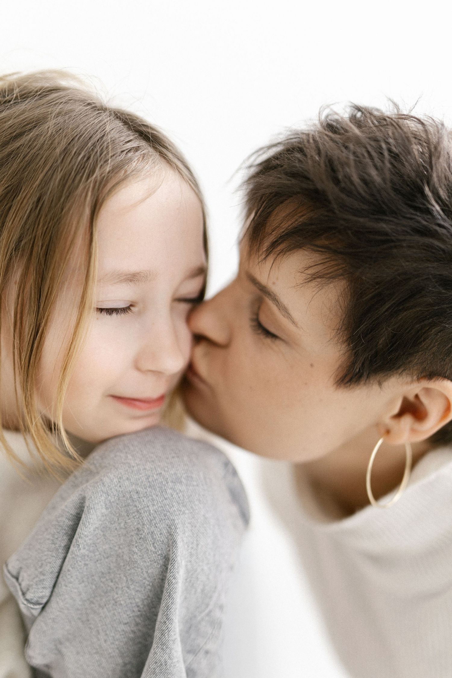 A romantic sequence showing tender kisses and intimate moments between two people in a soft, minimalist style.