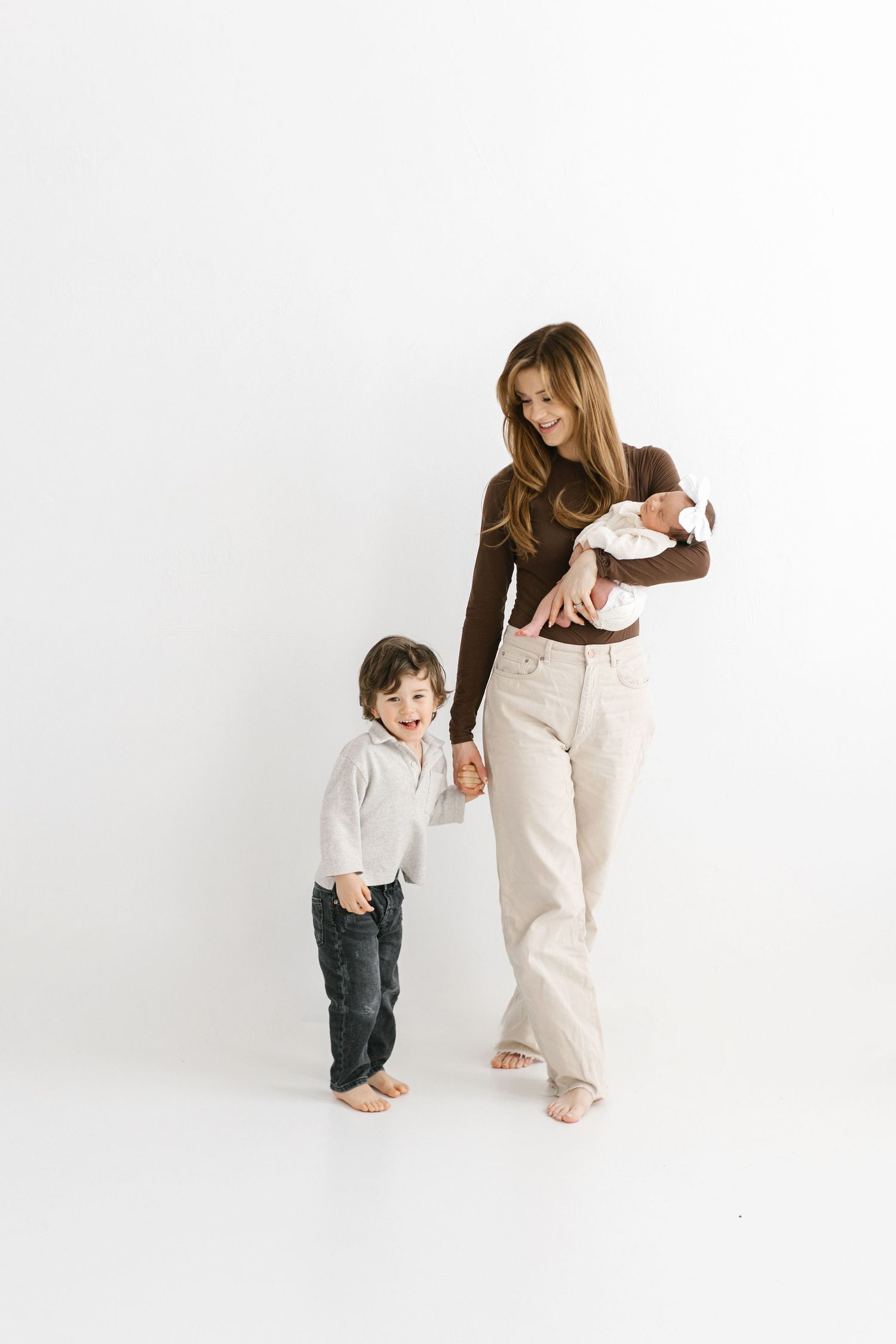 Parent and child playing together in white studio setting showing progression of playful movement and interaction.