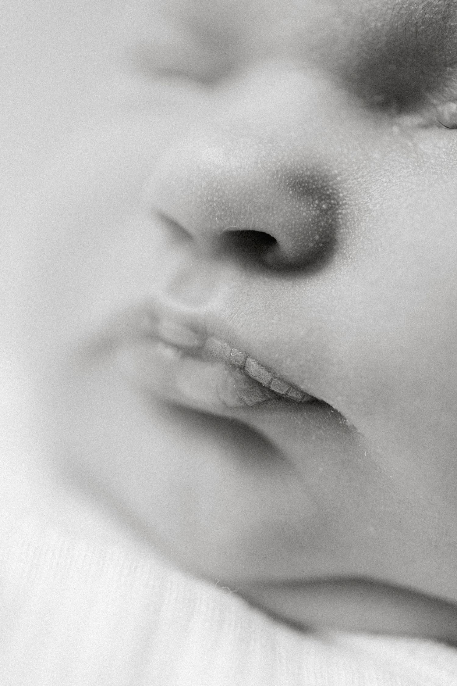 Extreme macro shots showing the delicate features of a baby's face in soft focus.