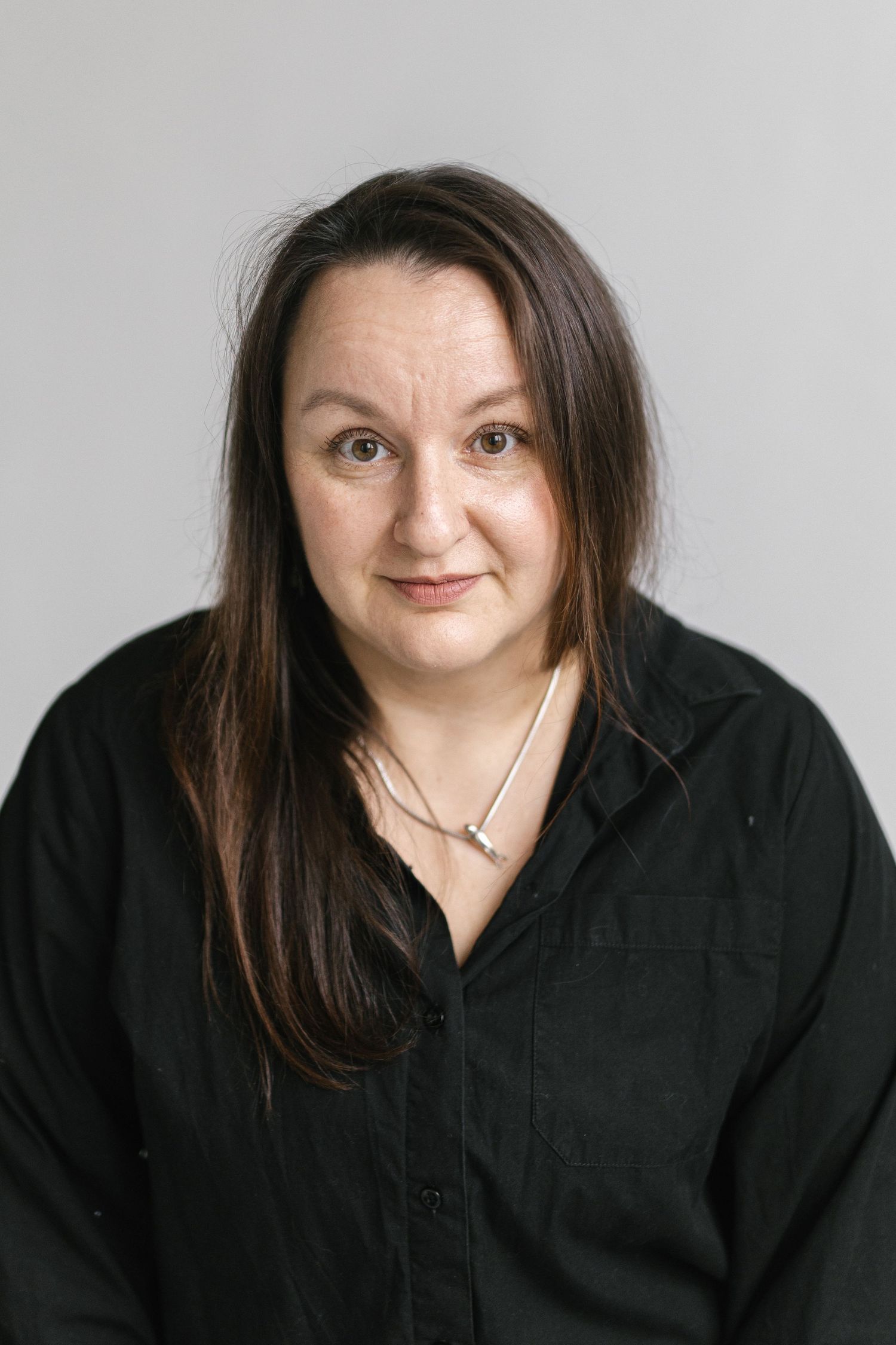 Portrait series showing expressive poses in a black shirt against a light background.