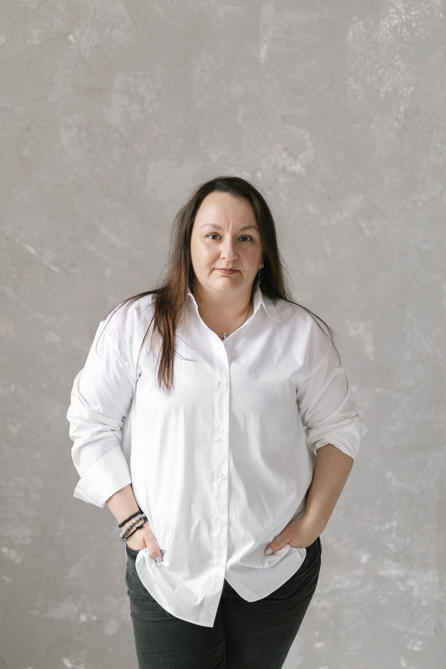 Professional studio portraits in classic white shirt and black pants combination.
