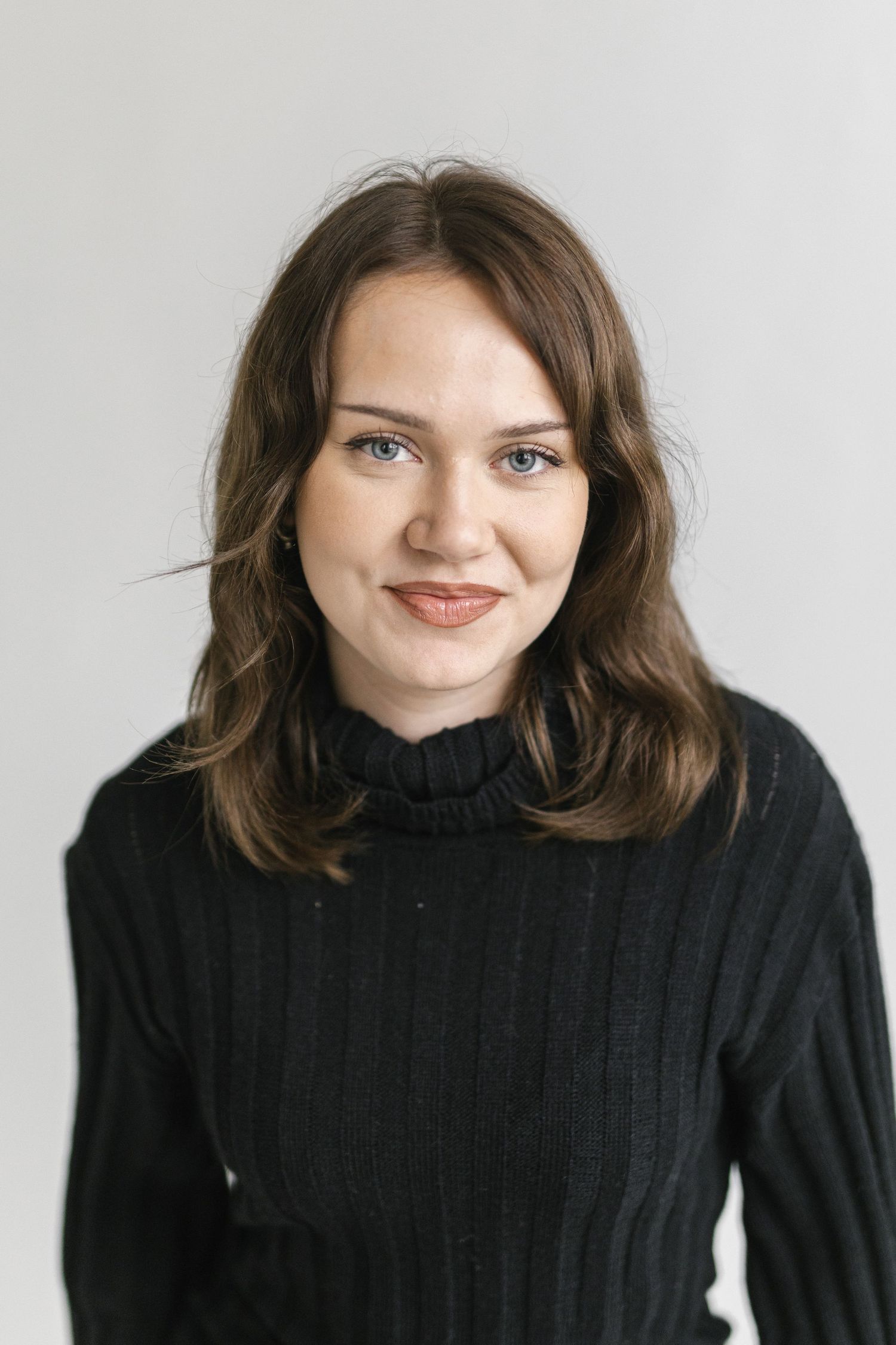 Portrait sequence in a black turtleneck sweater showing different angles and expressions.