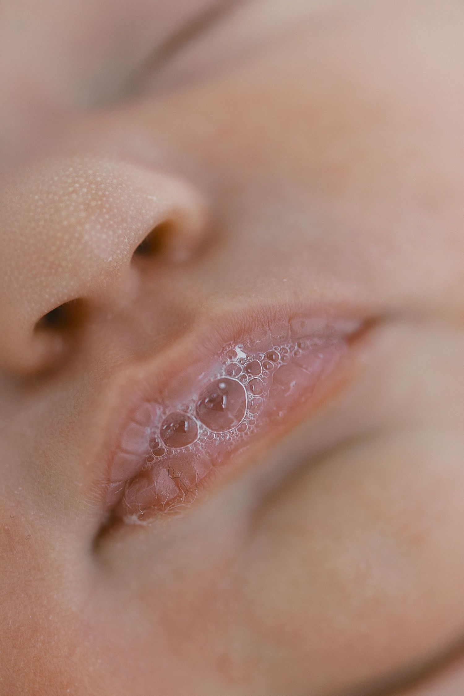 Extreme close-up photographs showing the delicate texture and detail of a baby's lips.