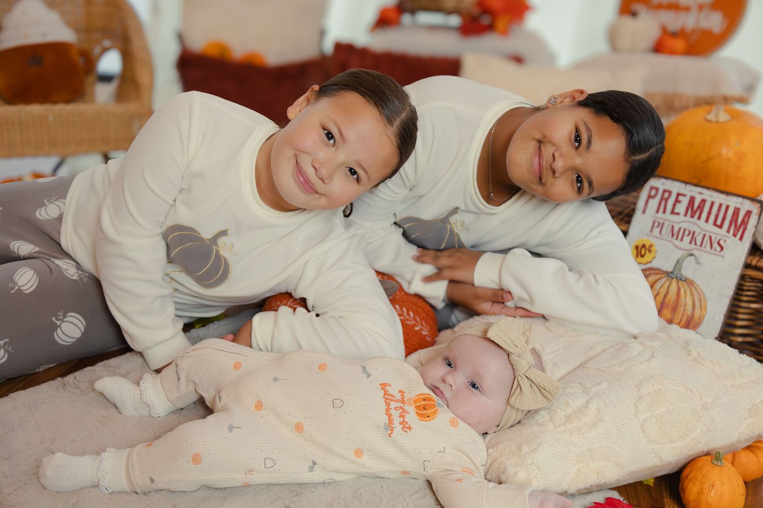 Family in matching gray pajamas relaxing together during holiday season.