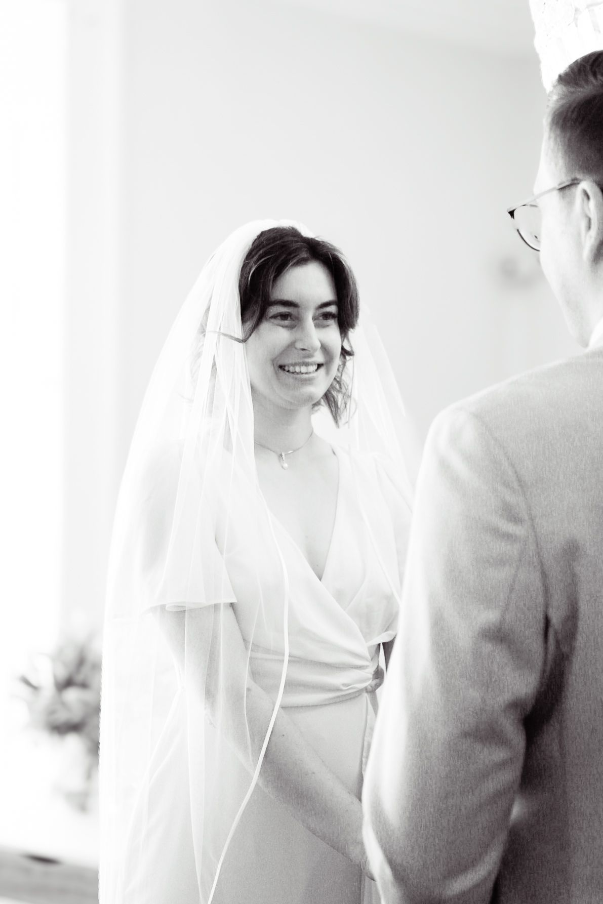 Black and white candid moment between a bride and groom.