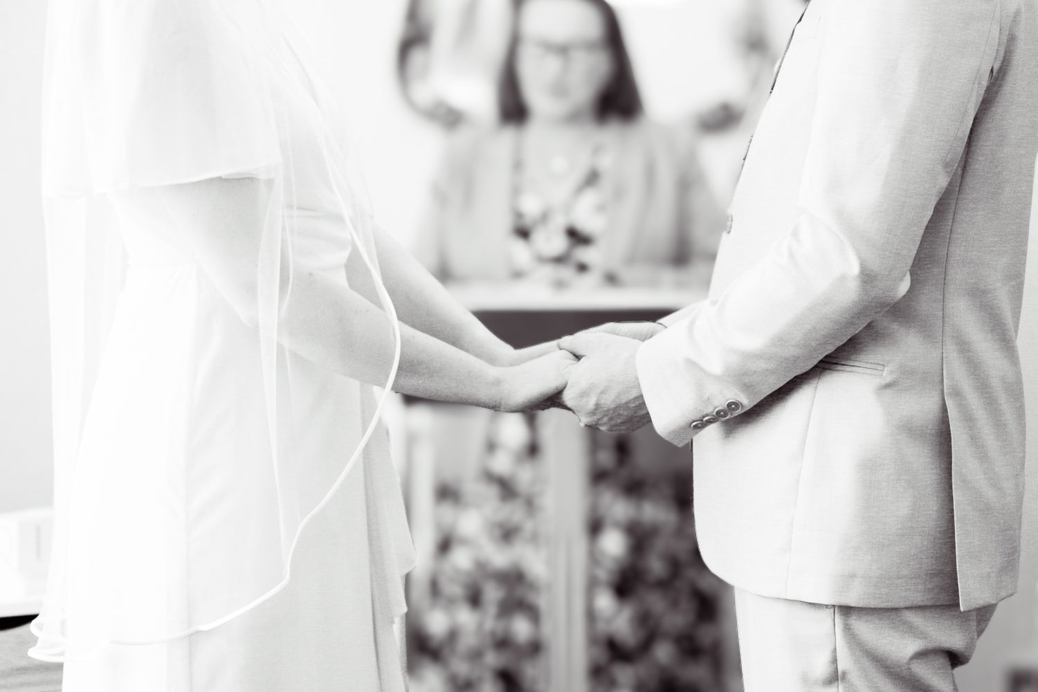Wedding celebration in white and pink attire during an indoor reception.