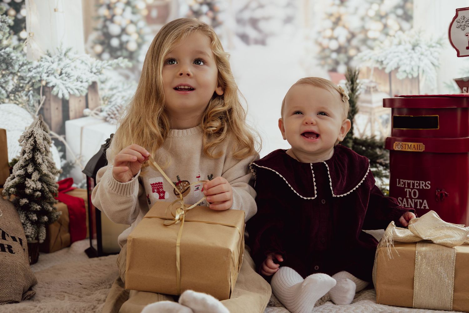 Holiday photo arrangement with wrapped presents and Christmas decorations in soft lighting.