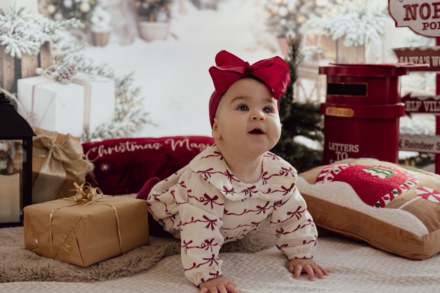 Holiday themed photo setup with North Pole signs and Christmas decorations in soft lighting.
