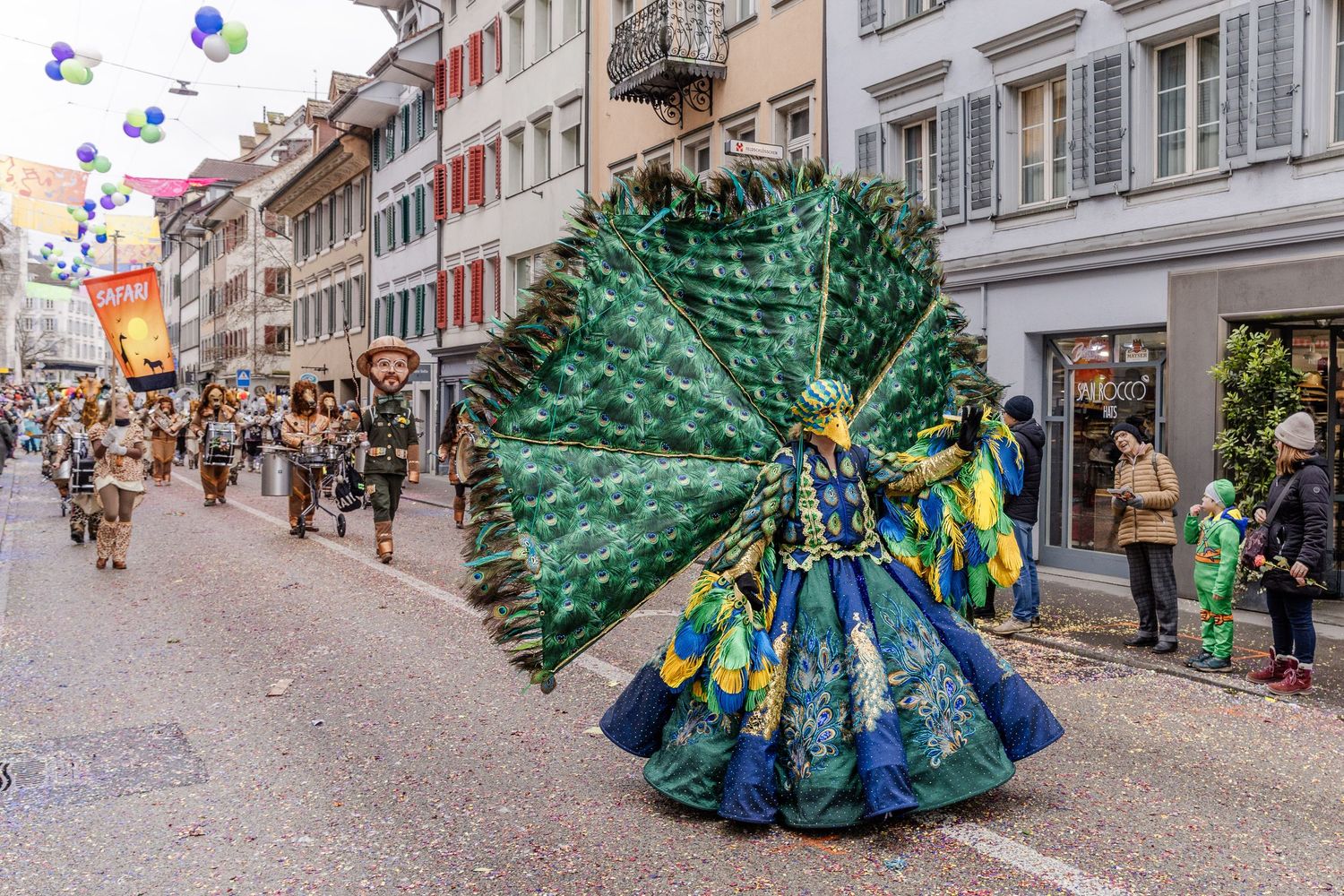 A person dressed as a peacock during a parade in the city in Switzerland