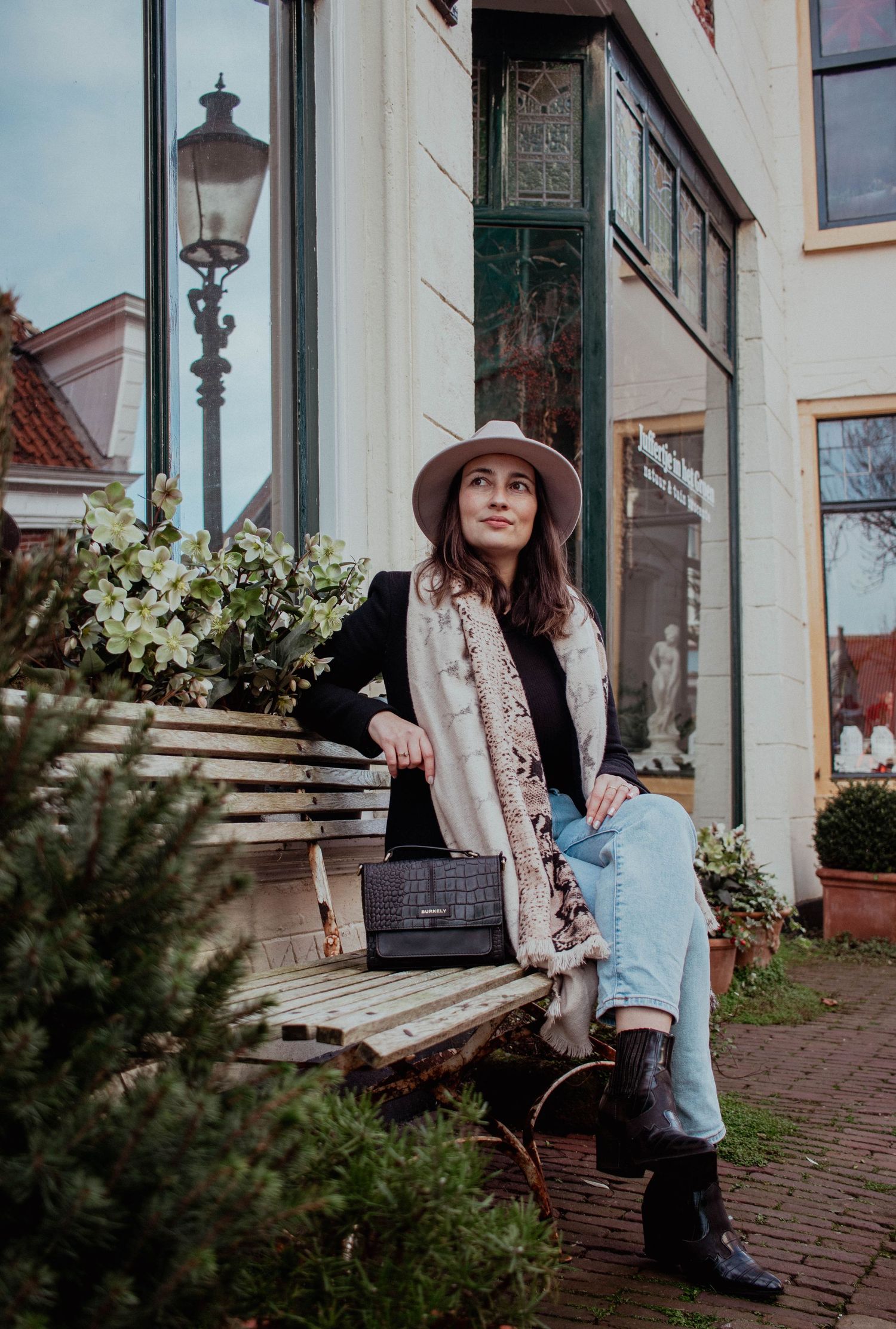 Woman sitting on a bench enjoying the weather during a lifestyle photo session