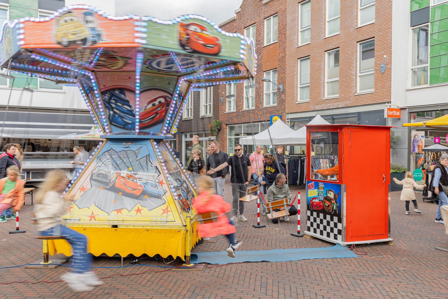 Kids enjoying the carousel on a summer event