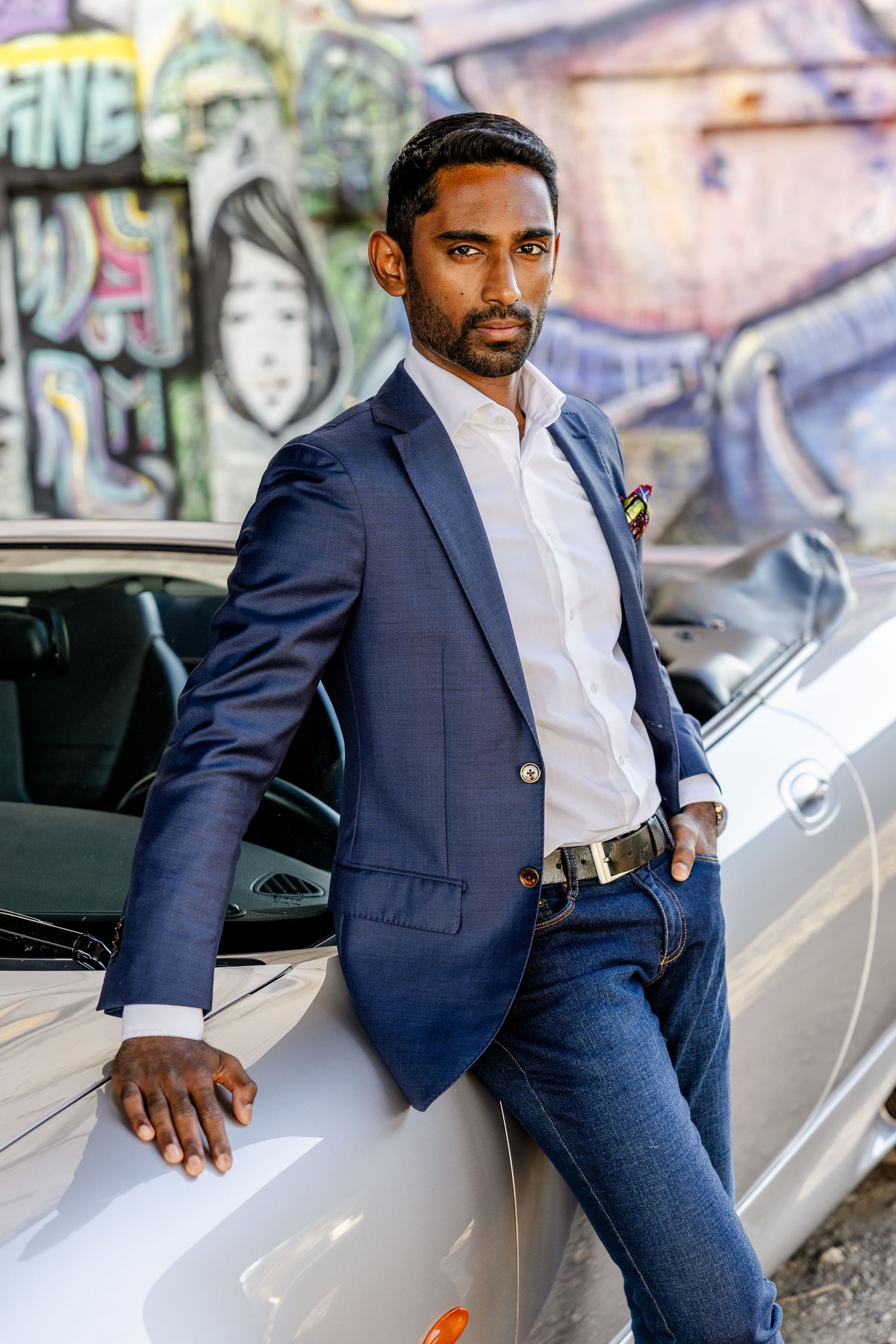Business man in a suit leaning against his car during a branding shoot