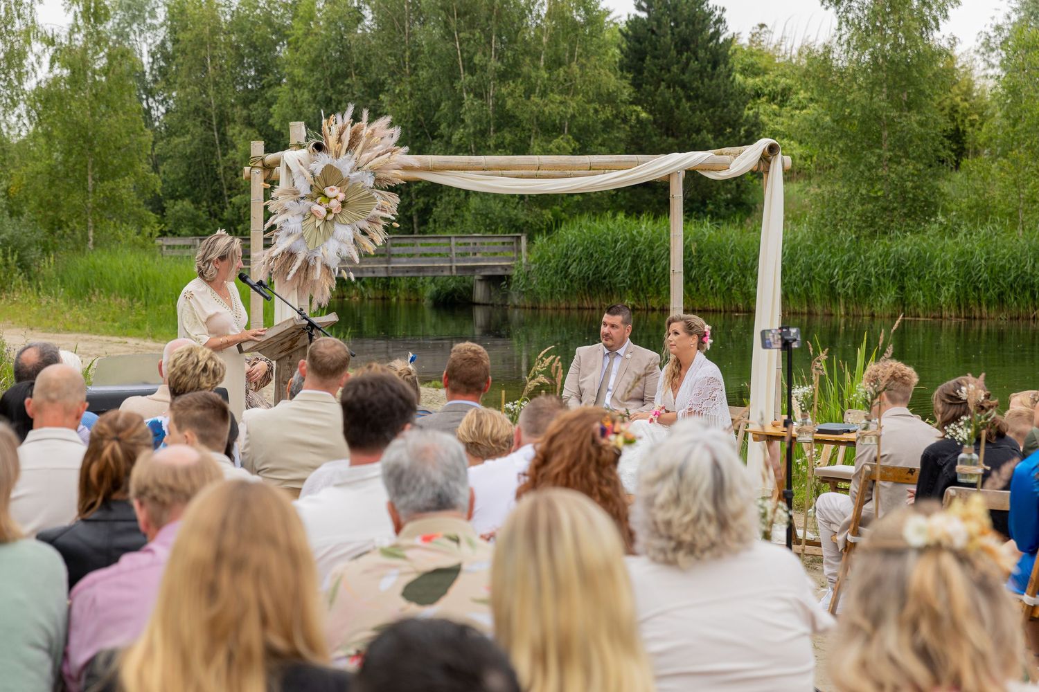 An overview photo of the location during the wedding with the bride and groom and family and friends