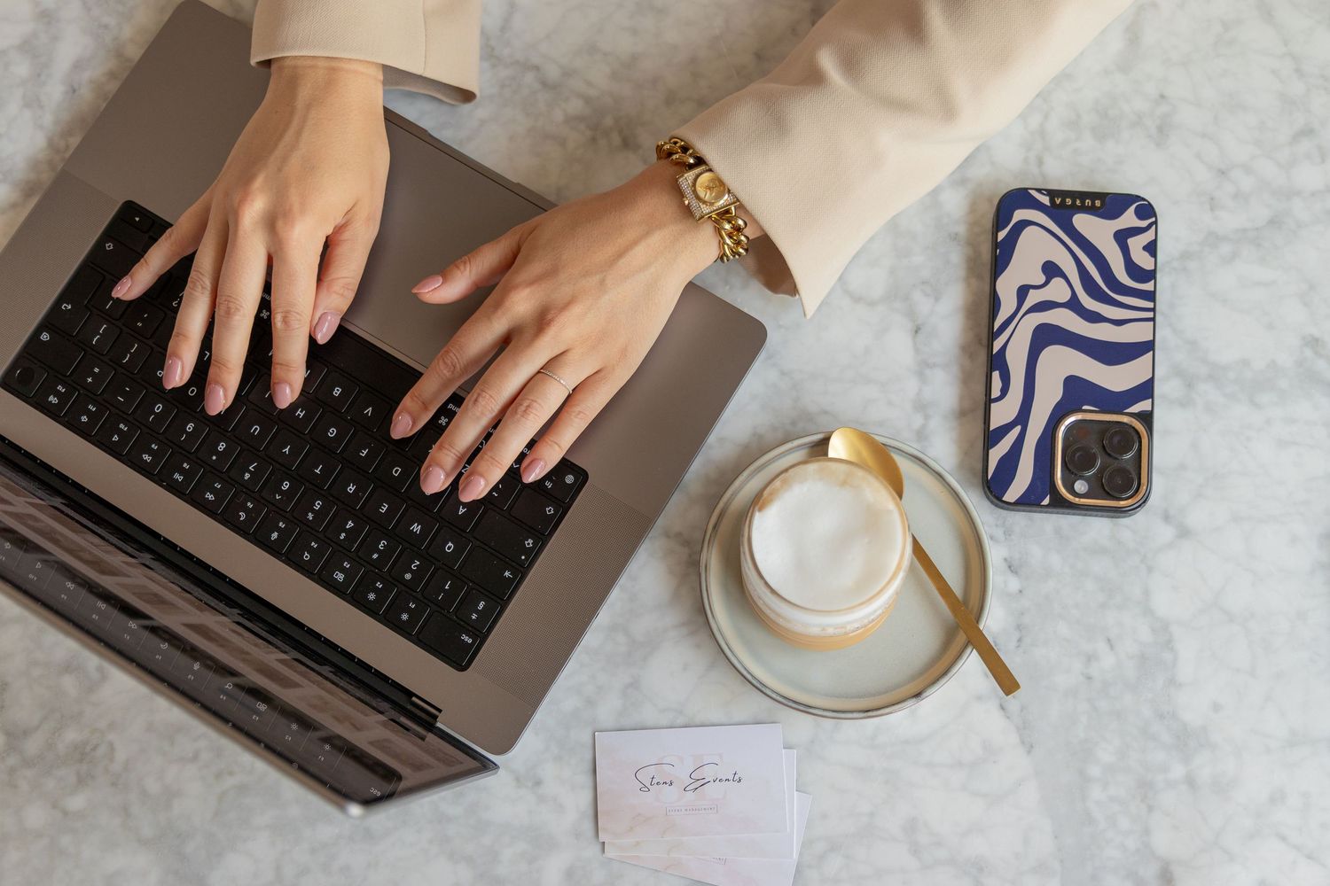 Female entrepreneur working on her laptop during a branding photo session