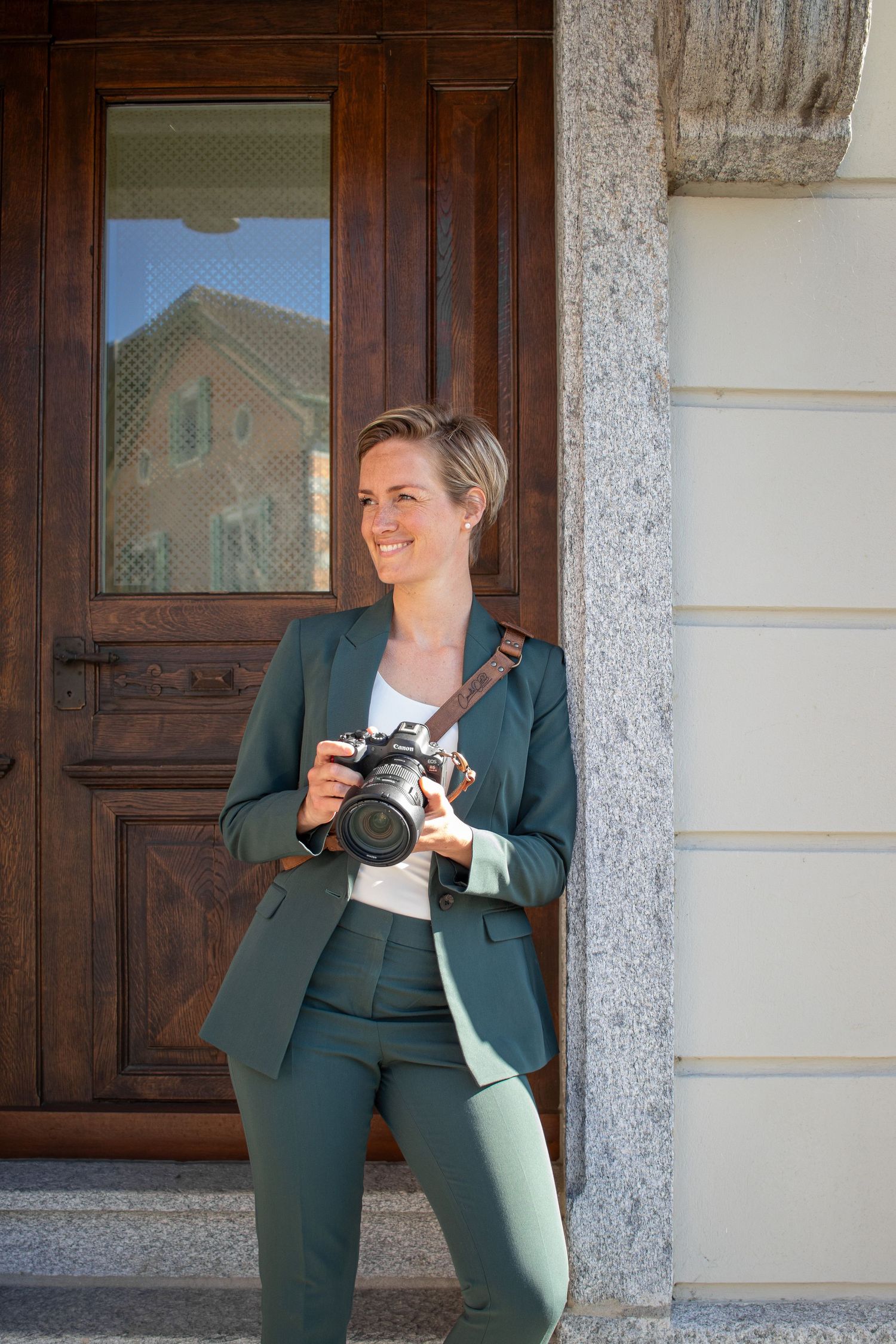 Photographer holding a camera and smiling