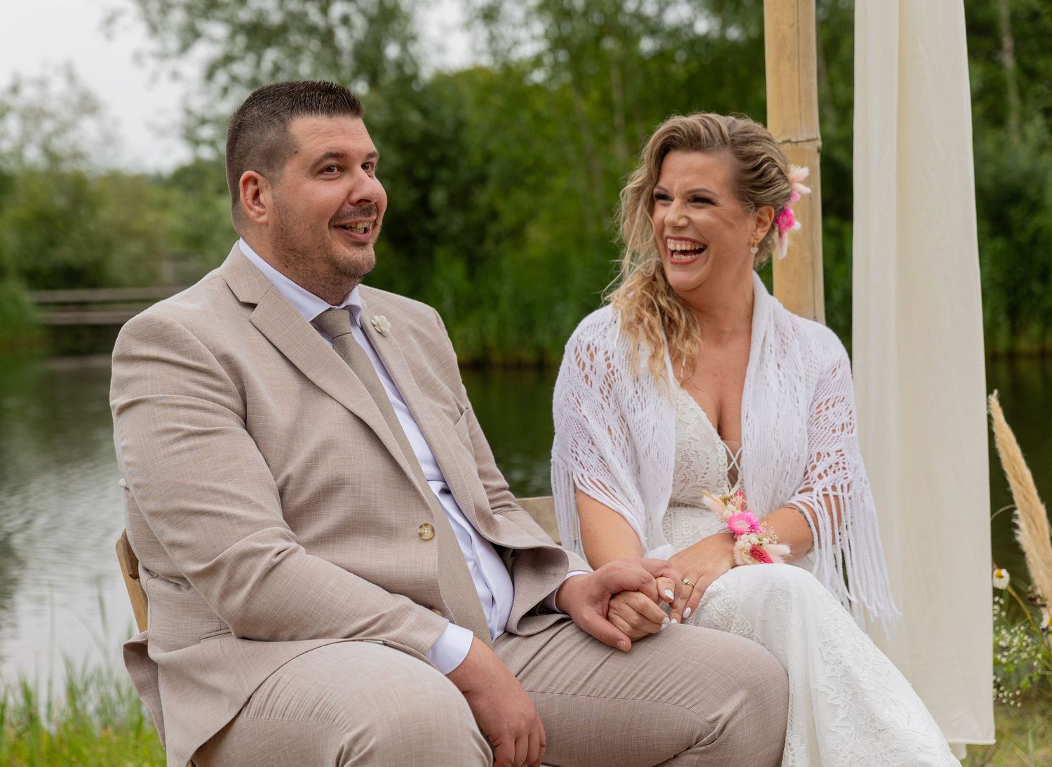 The bride and groom holding hands an laughing at the wedding ceremony