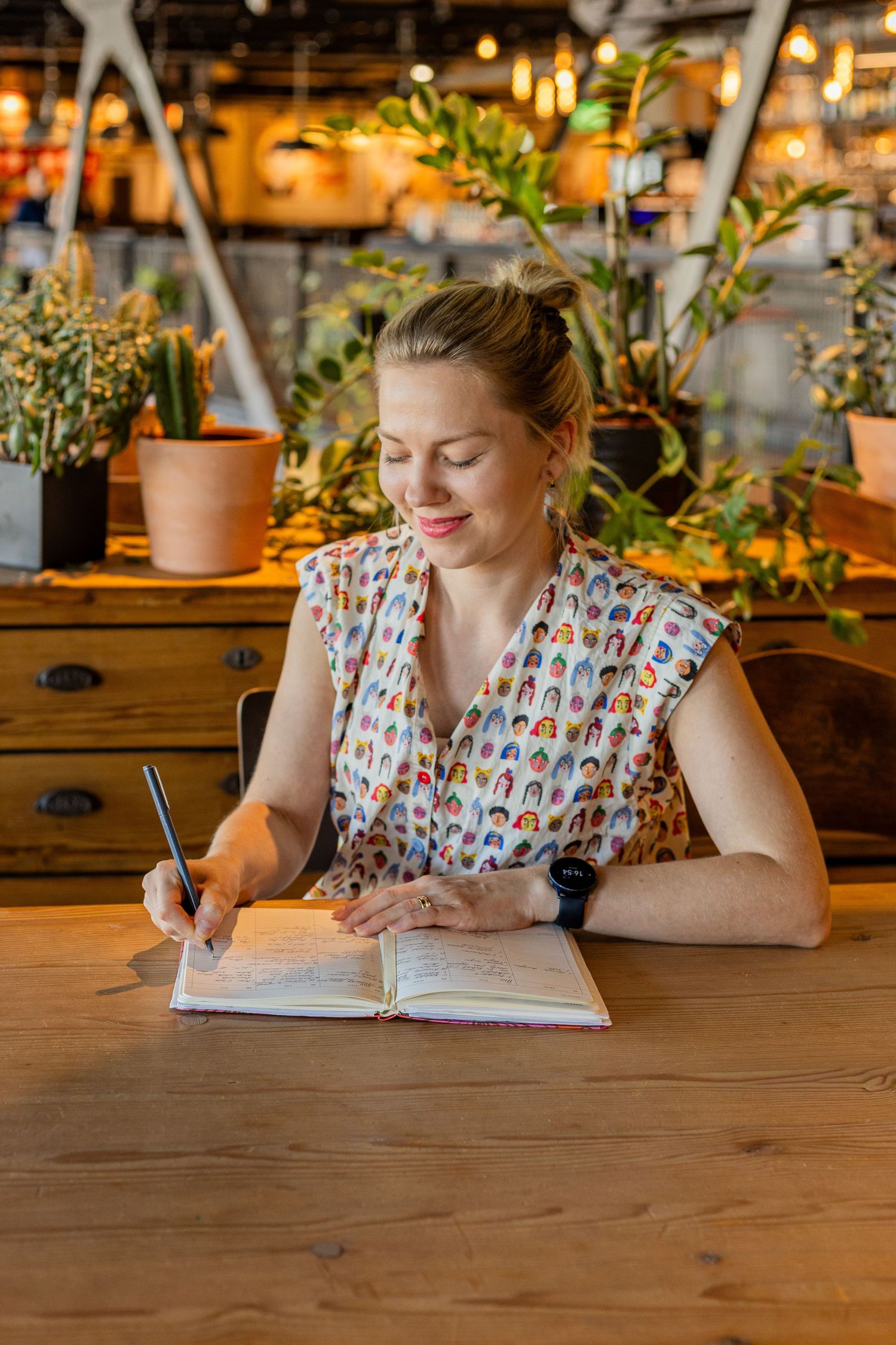 Branding photoshoot of a visual merchandiser writing in her journal
