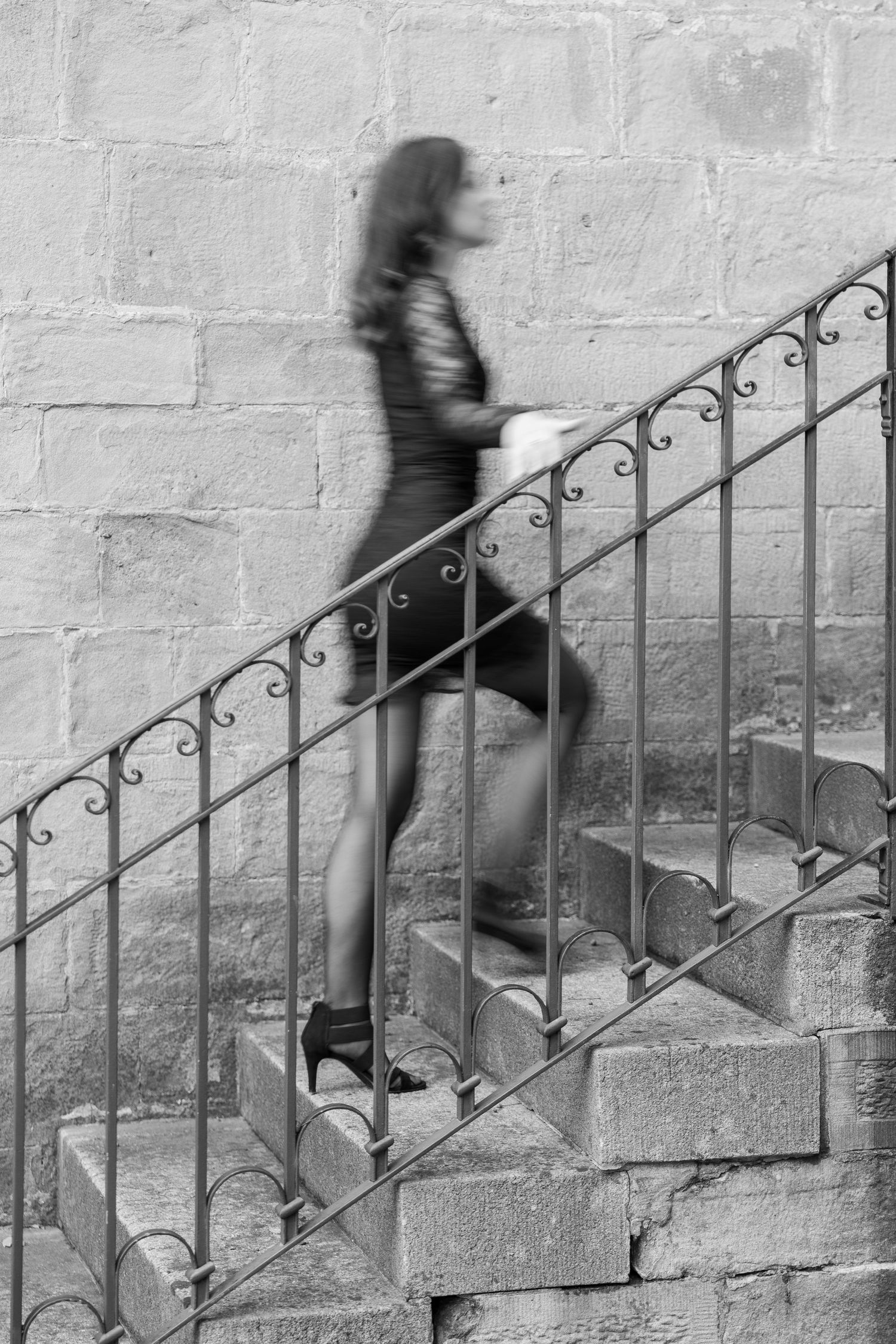 Female model walking up the stairs with moving action in the photo