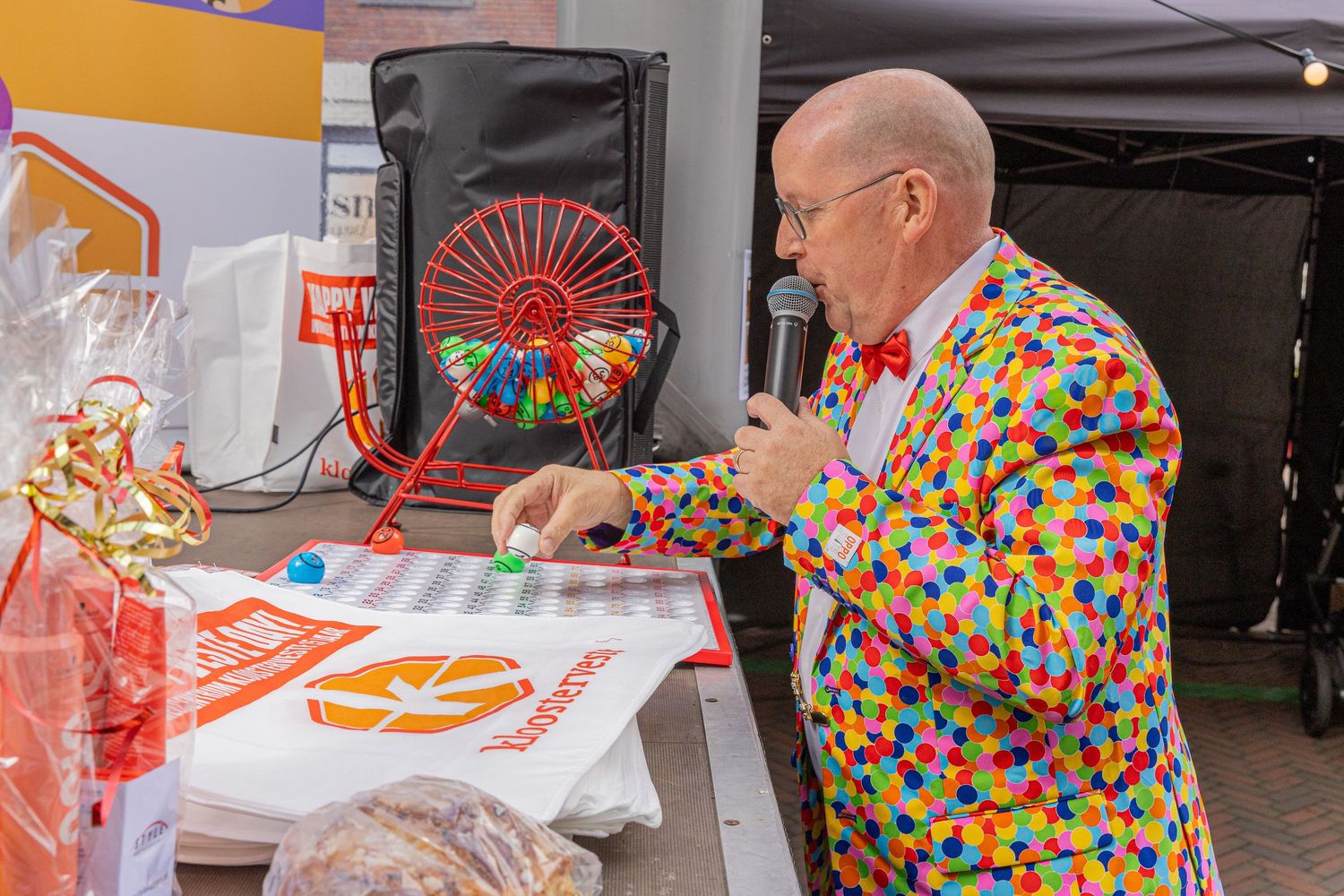 The bingo master calls out the numbers and hands out the prizes