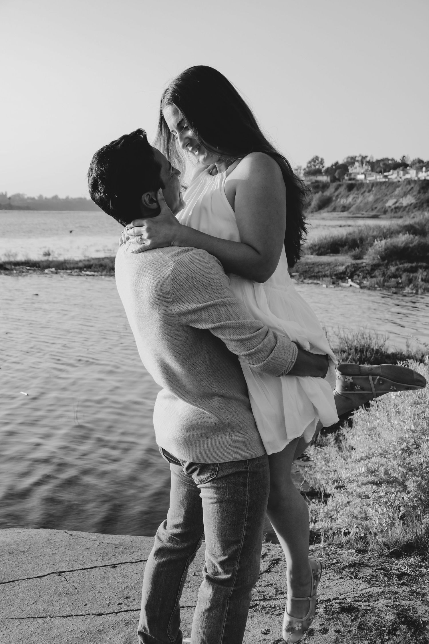 A black and white capture of a romantic moment by the waterfront.