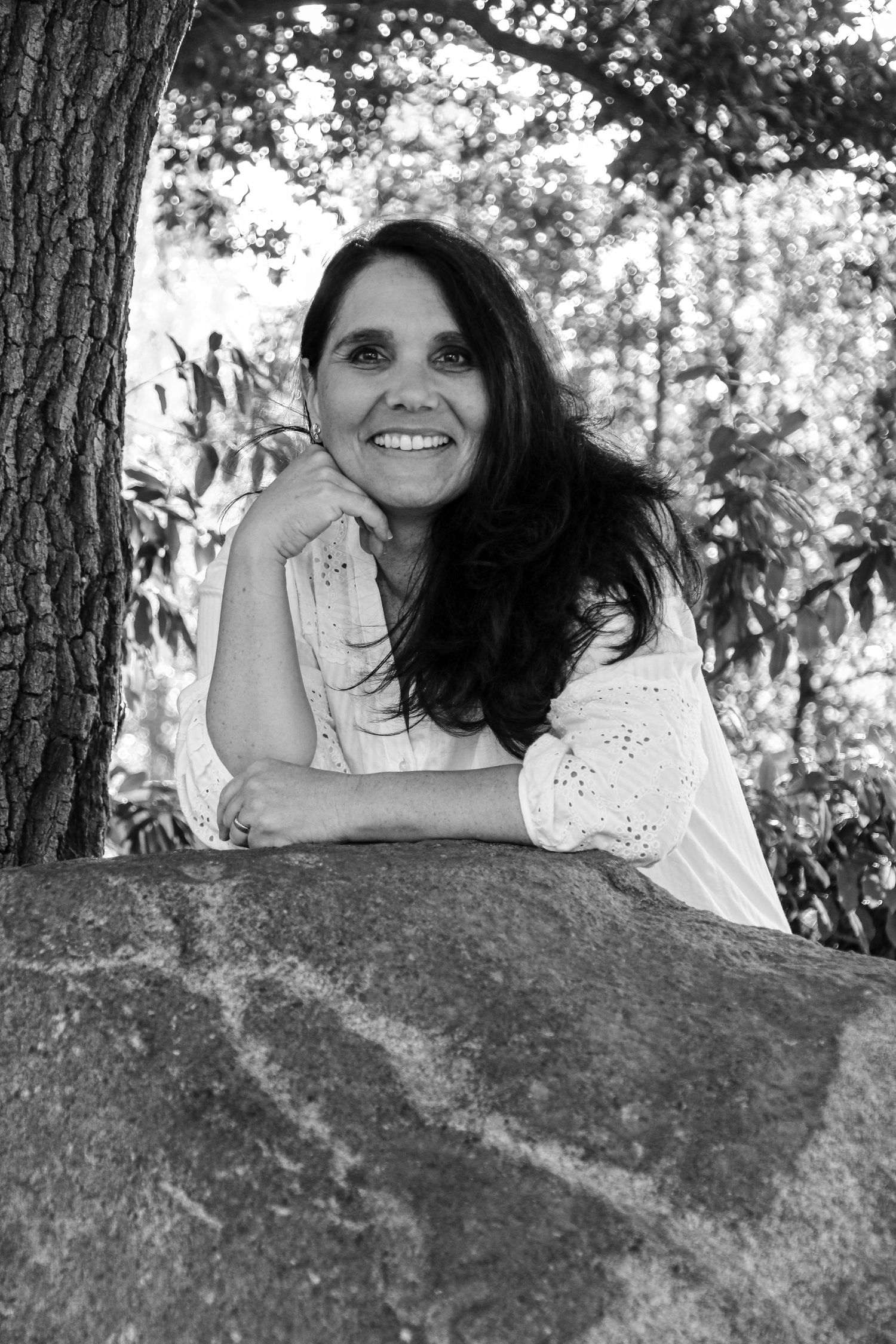 Black and white photo series of a person lying on a rock in a natural outdoor setting.