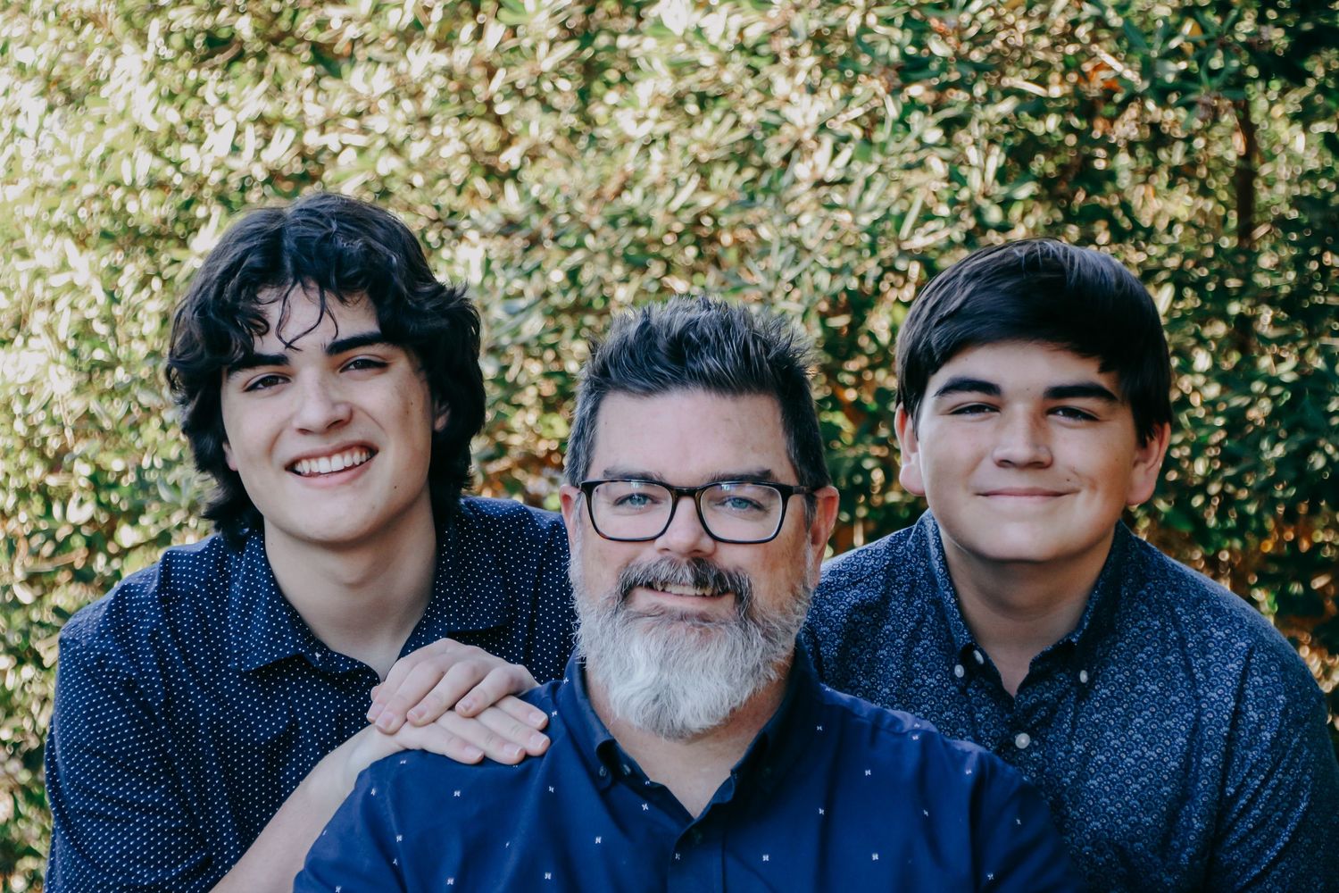 Natural family portrait session captured in front of autumn trees.