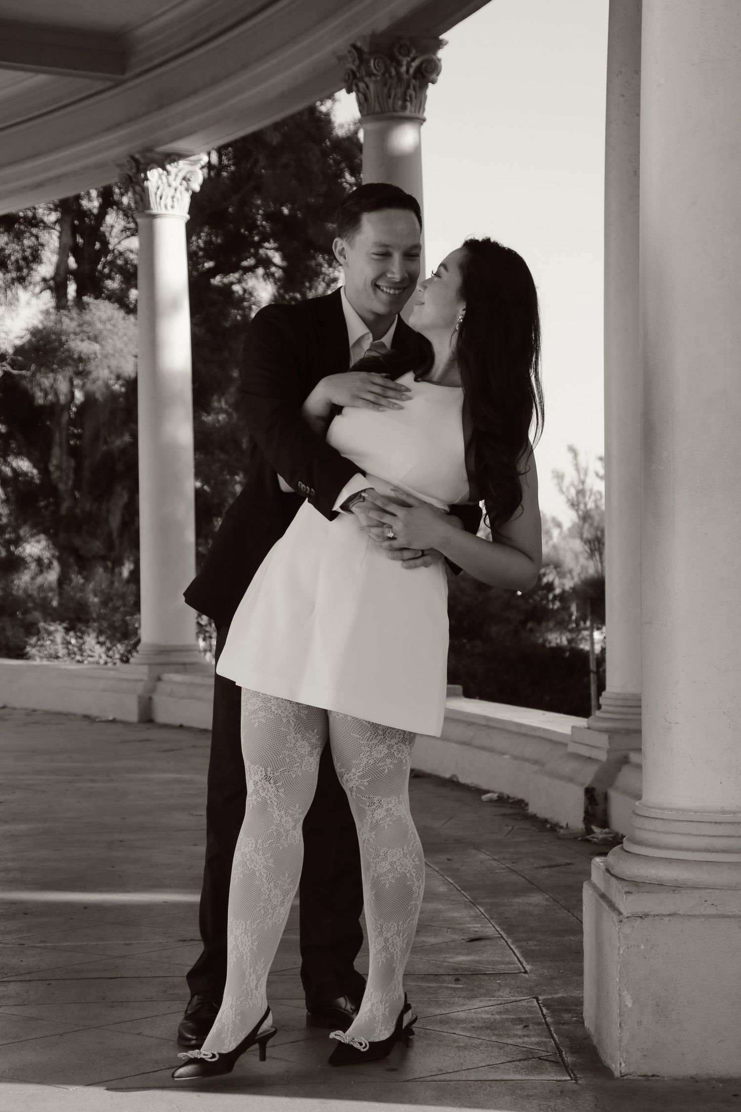 A romantic black and white photo sequence of a couple in formal wear embracing on a columned porch.