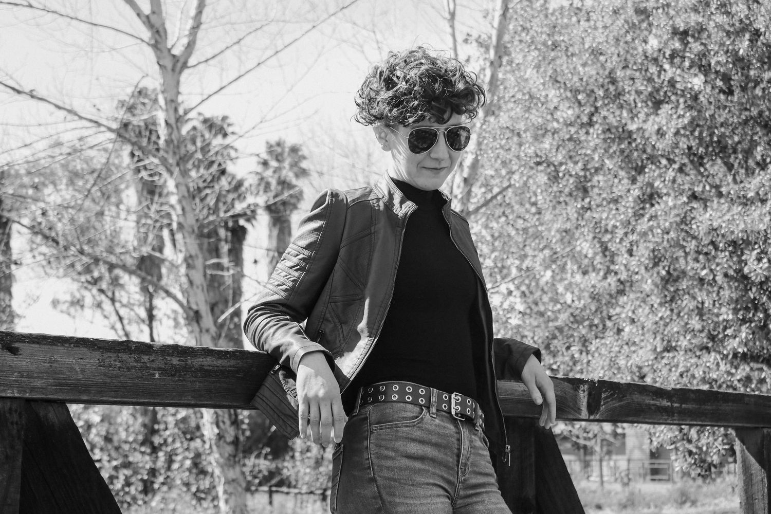 Black and white fashion photography highlighting contrast between modern style and rustic location.