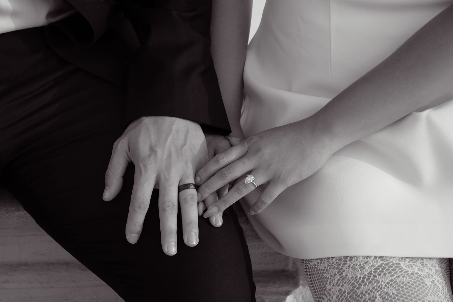 Close-up detail shots of hands and formal attire in black and white.