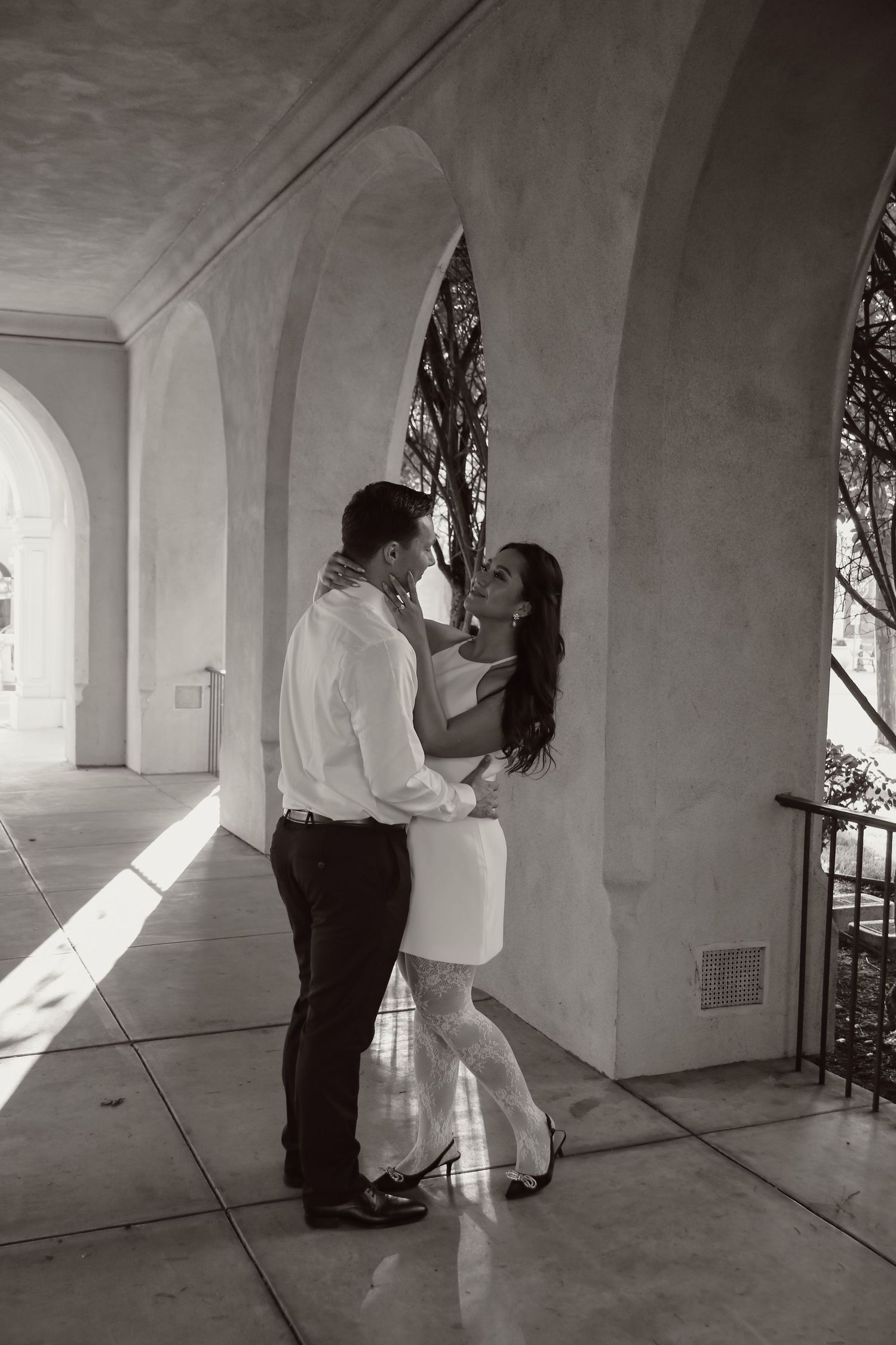 Black and white photo sequence showing a couple's tender moments in a covered walkway.