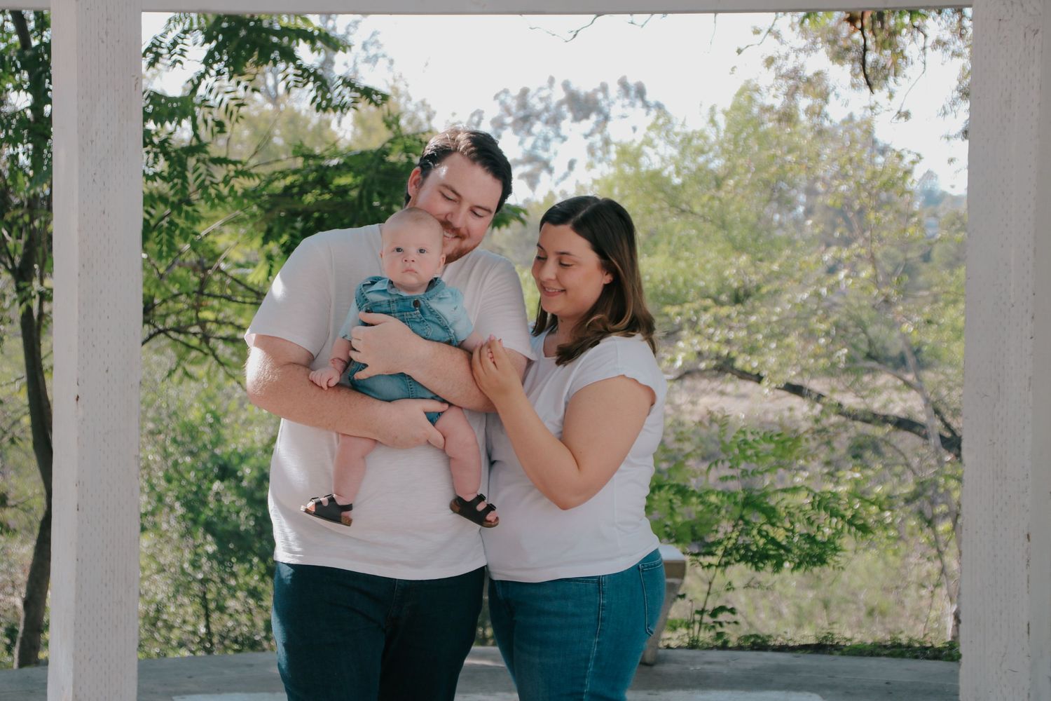 A trio of family photos taken on outdoor steps with natural greenery in the background.