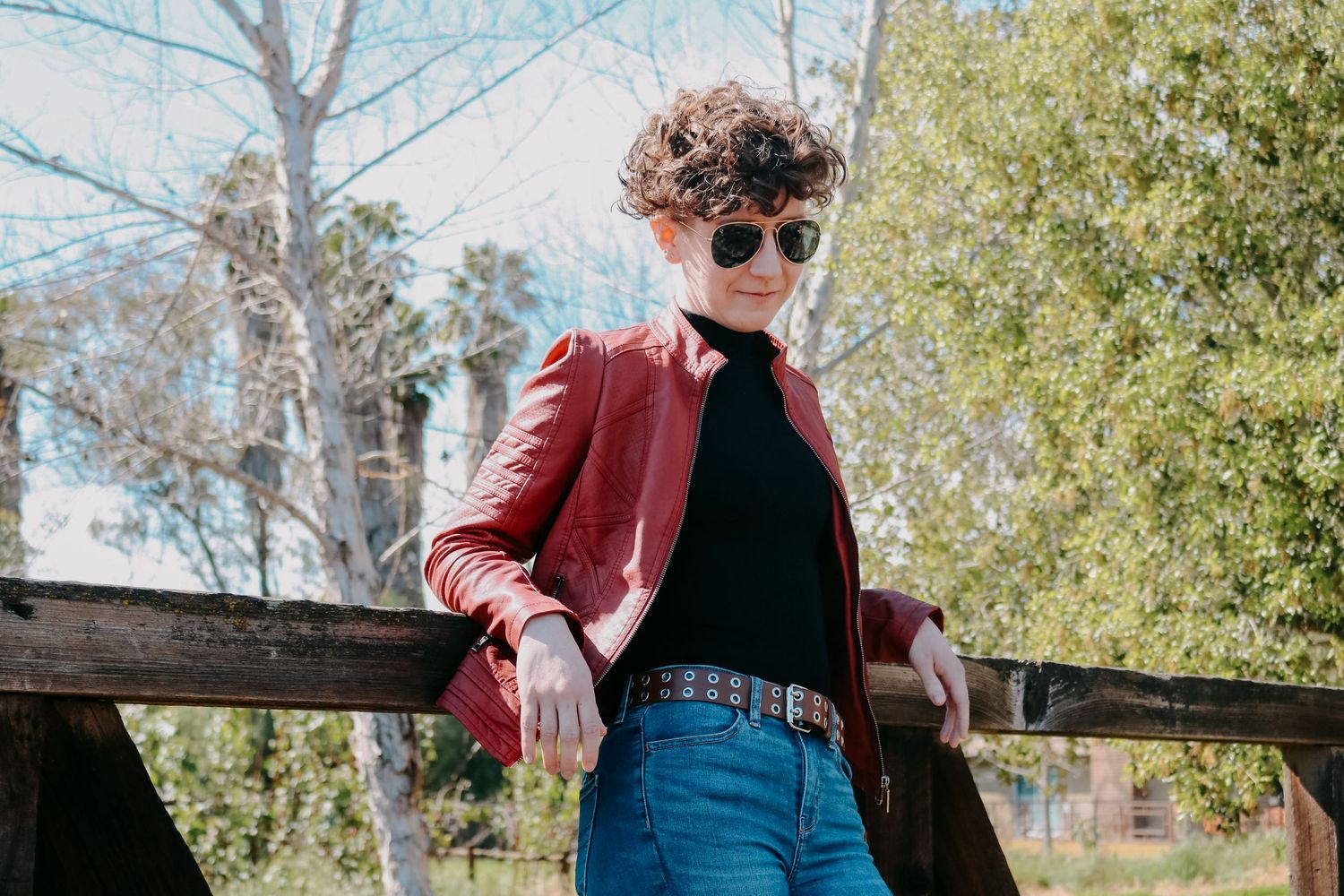 Editorial fashion shoot combining urban style with rural railway scenery.