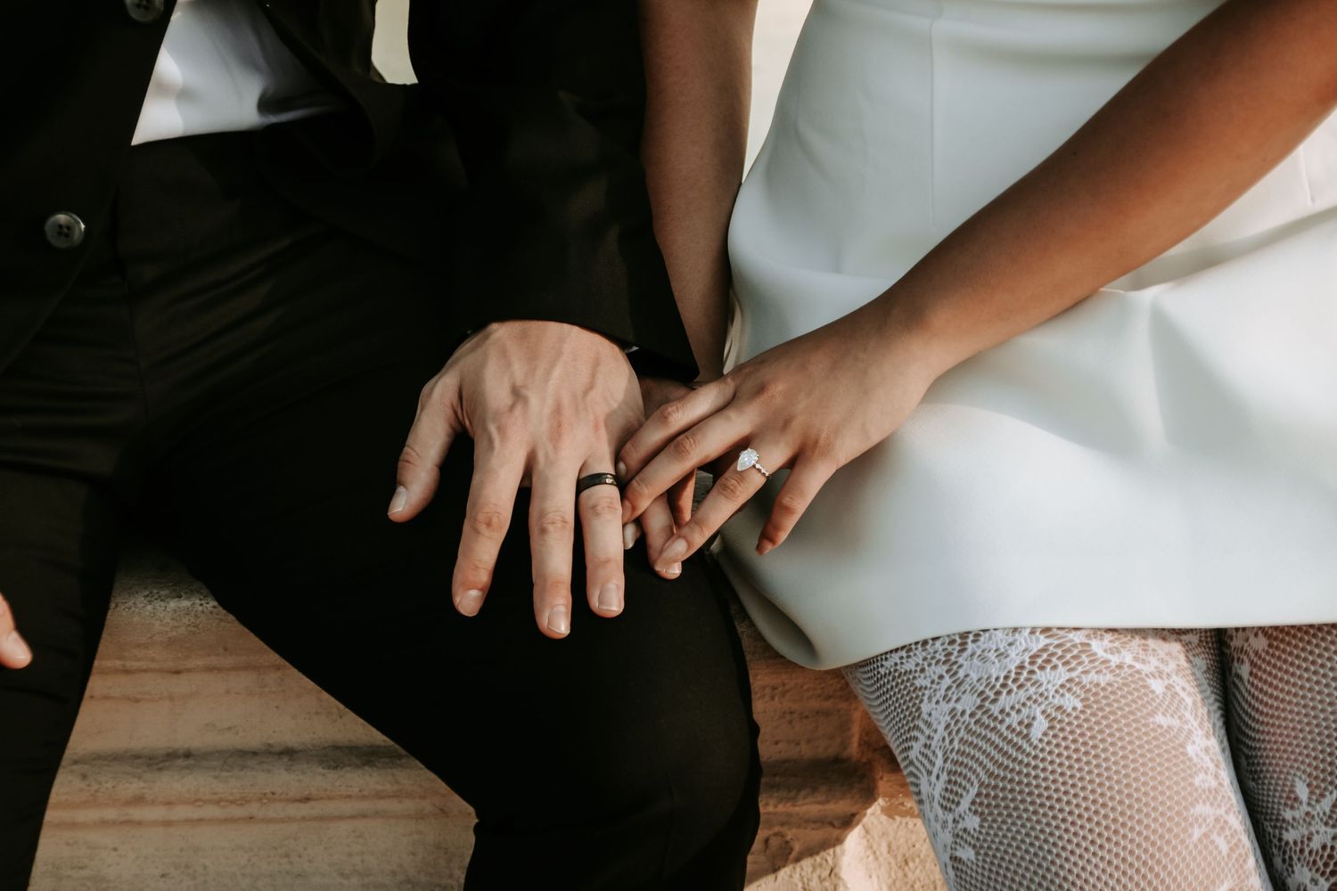 Artistic detail shots showing hands and lace against formal wedding attire.