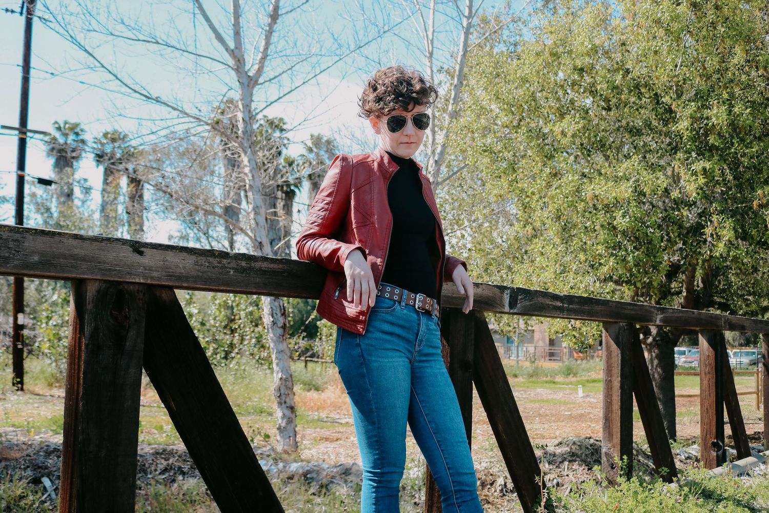 Casual street style photography featuring vintage-inspired outfit on historic railway setting.