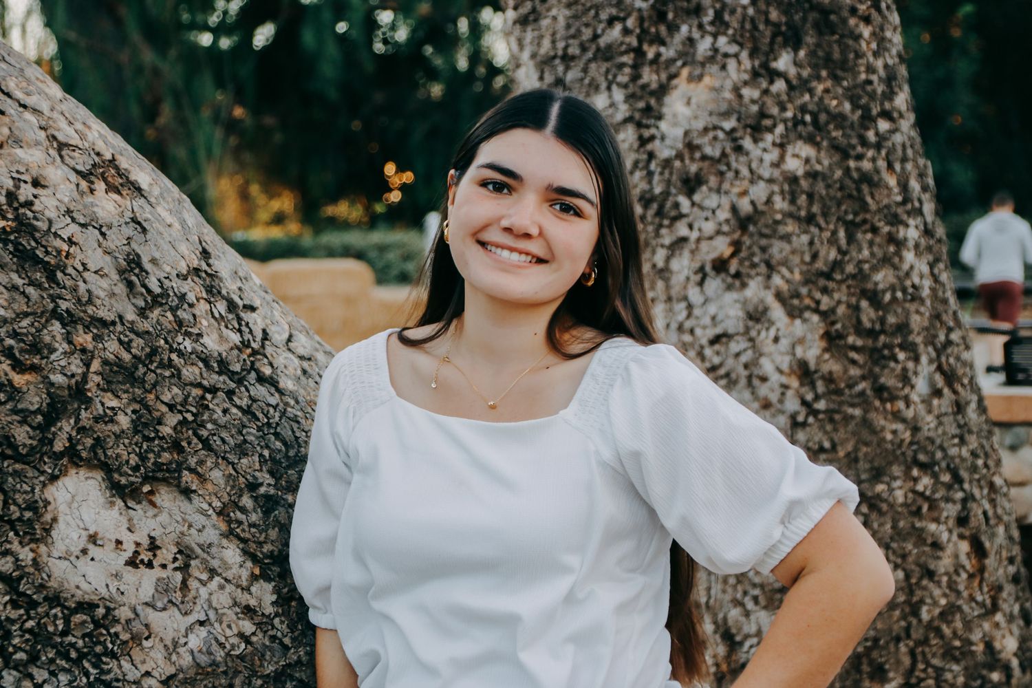 Candid outdoor portraits featuring natural lighting and tree backdrop.