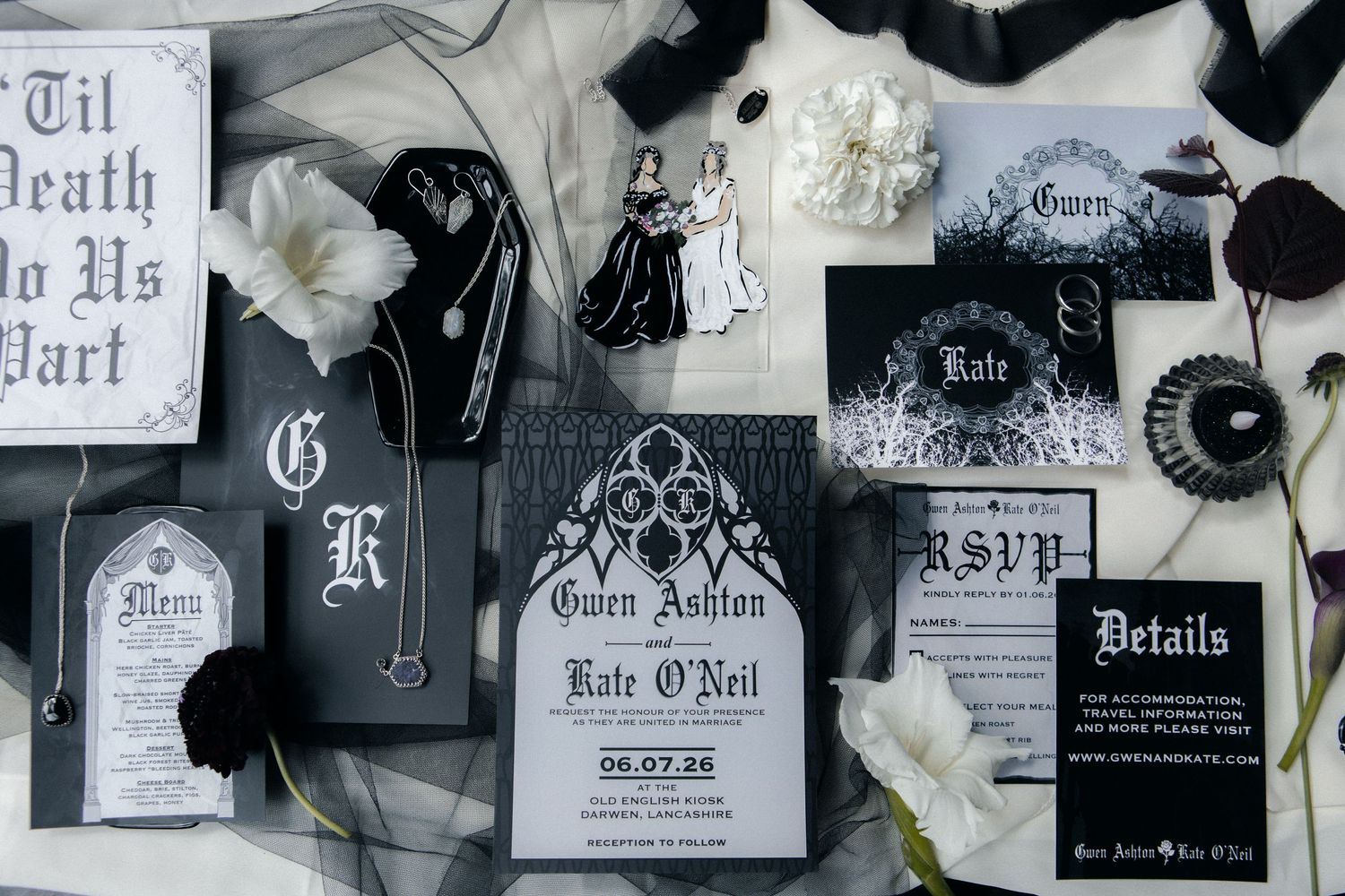 Gothic wedding stationery suite in black and white featuring ornate invitations, RSVP cards, and details cards with dark floral accents.