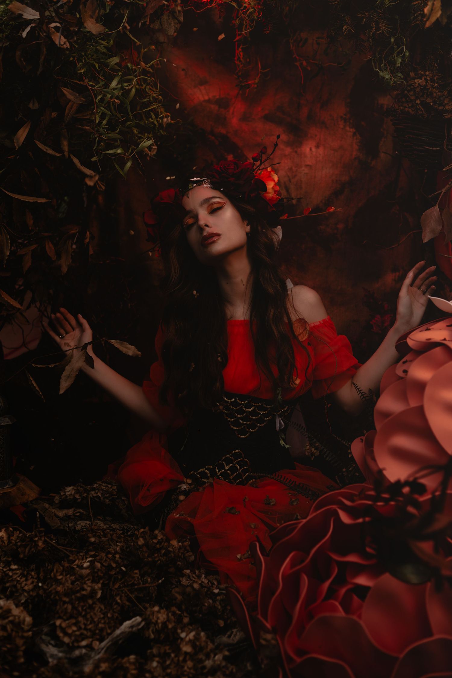 A dramatic portrait in red features a gothic-styled scene with roses and moody lighting.