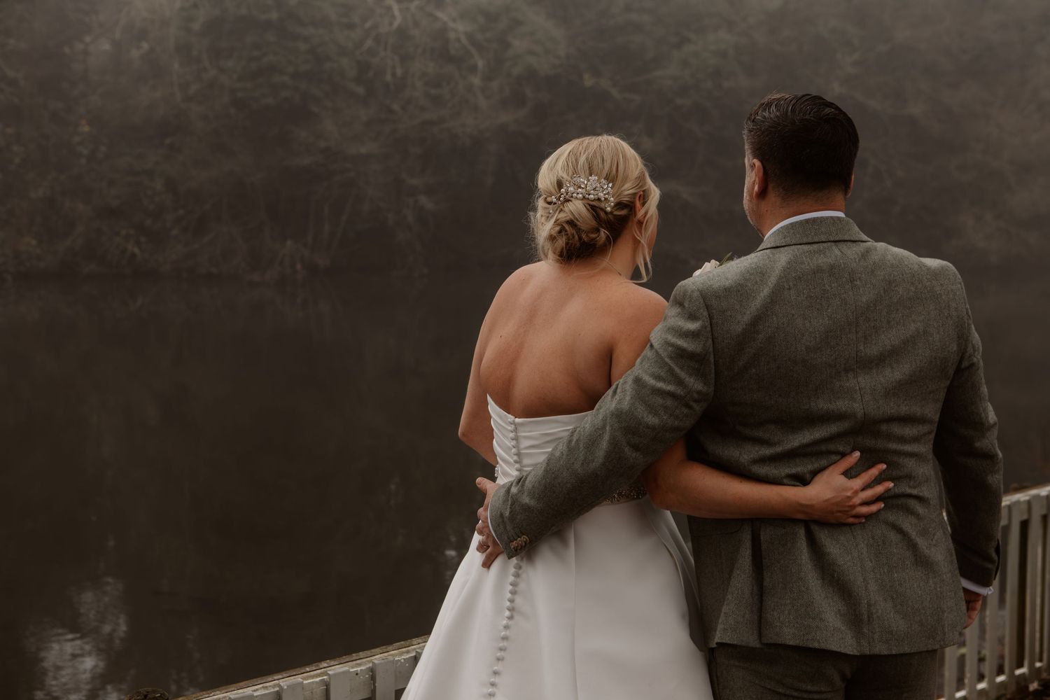 A black and white wedding photo series showing intimate moments between a couple in a romantic setting.