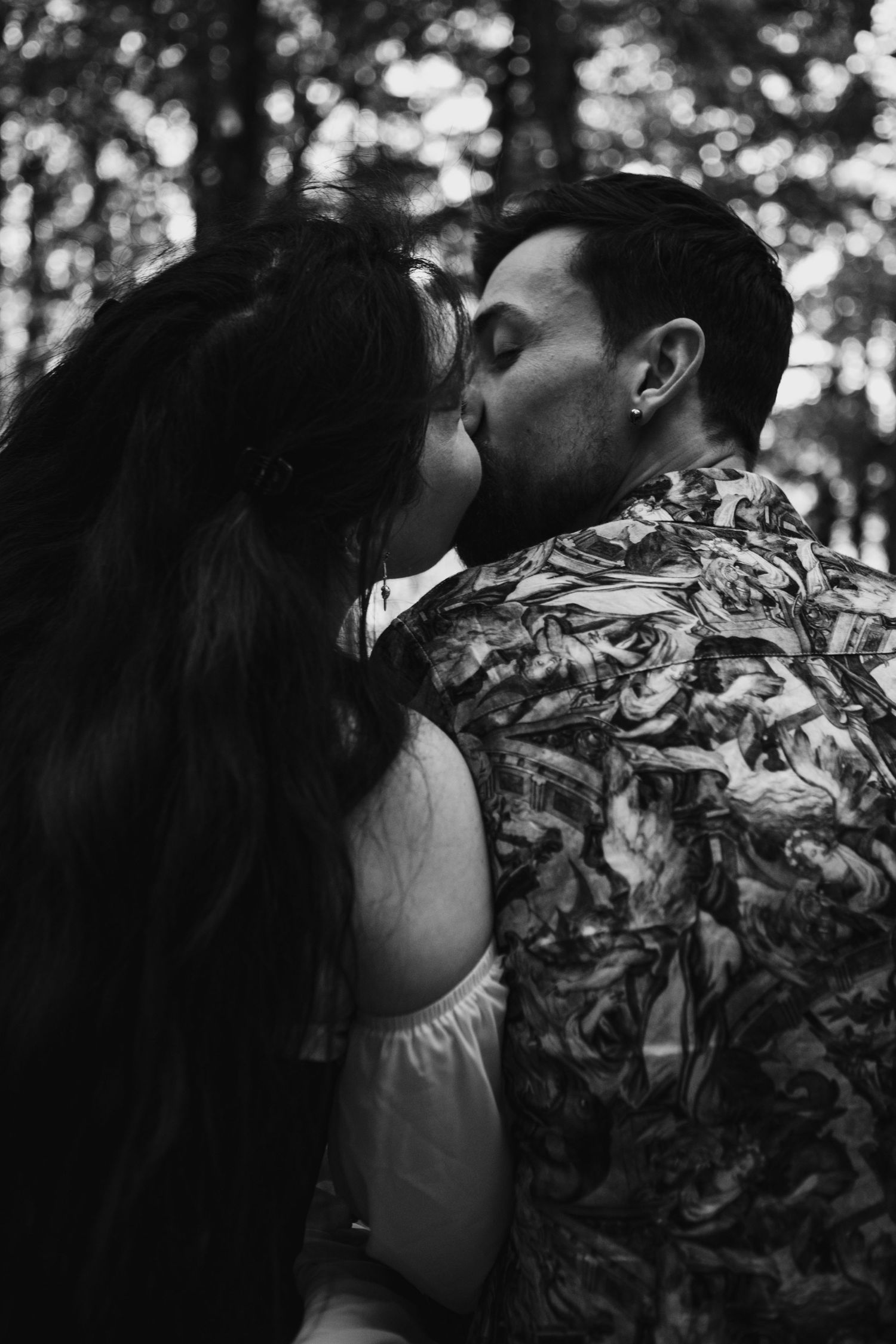 A black and white series of intimate portrait photos showing a woman in a floral dress against a blurred outdoor background.