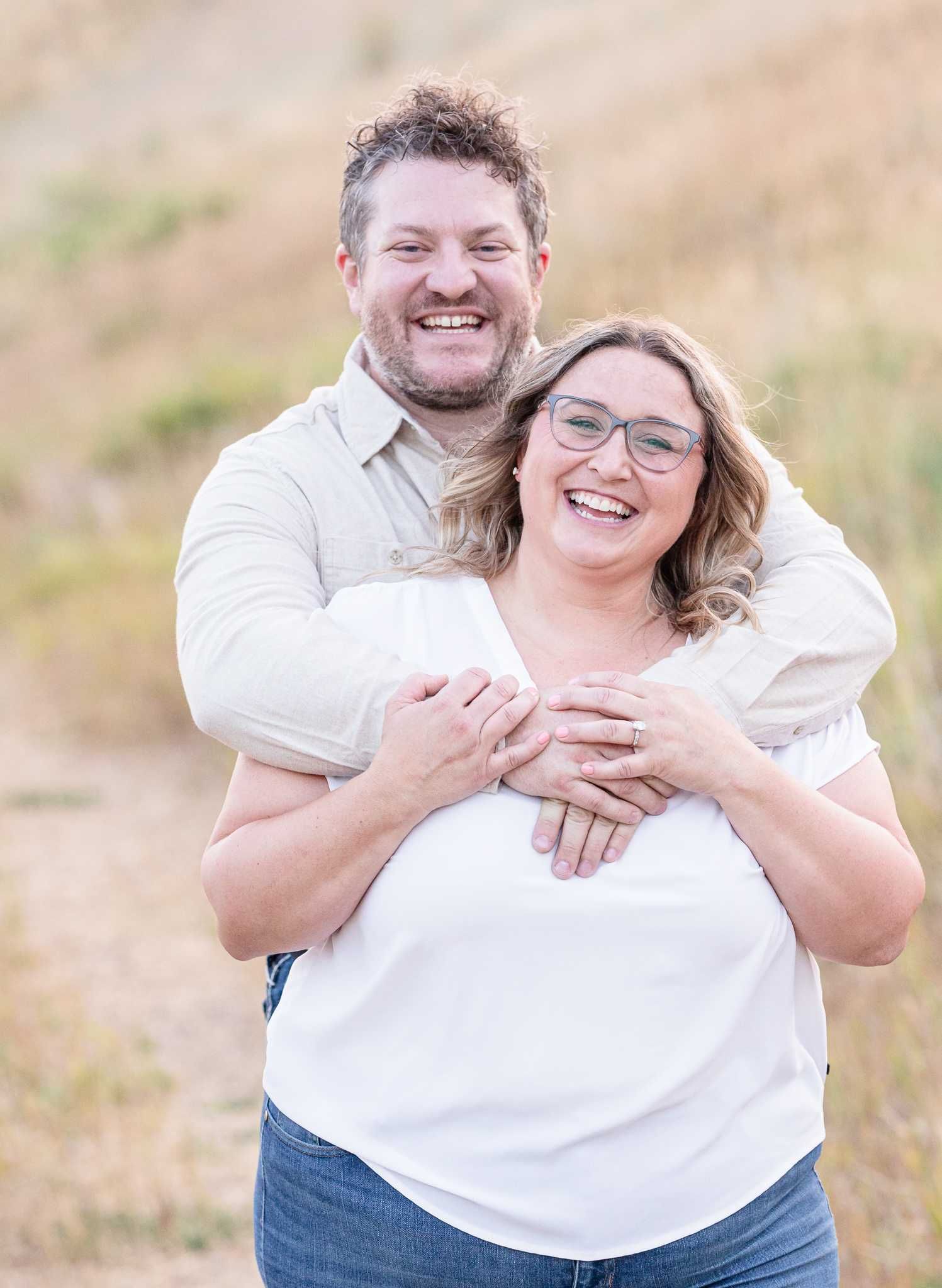 Loving embrace captured in golden hour lighting.