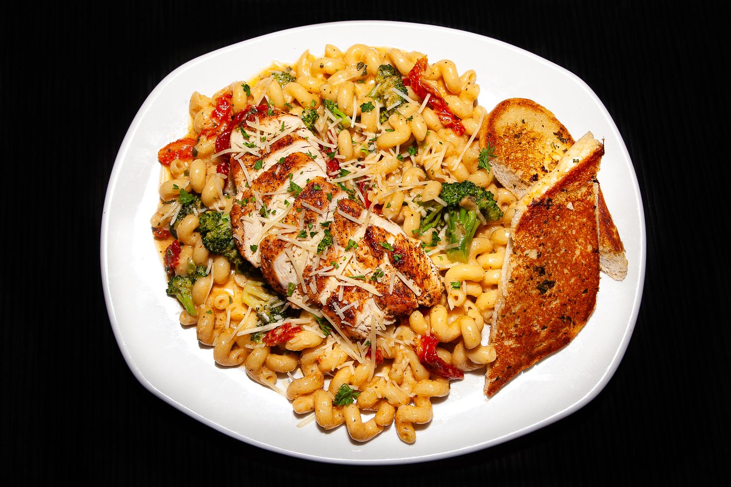 Studio photo of dish with chicken and mac and cheese