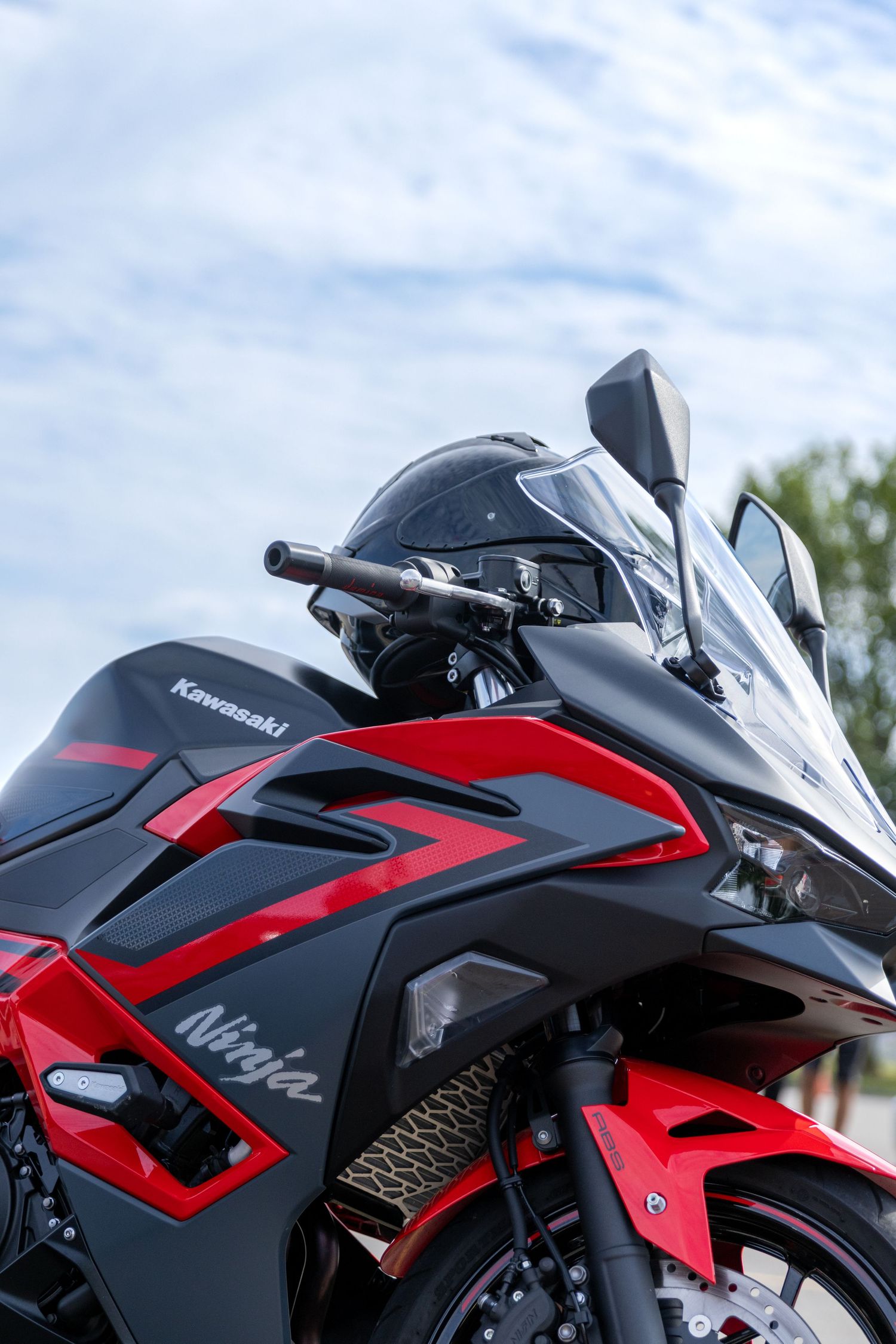 Multiple side views of a sleek black and red Kawasaki Ninja motorcycle emphasizing its aerodynamic design features.